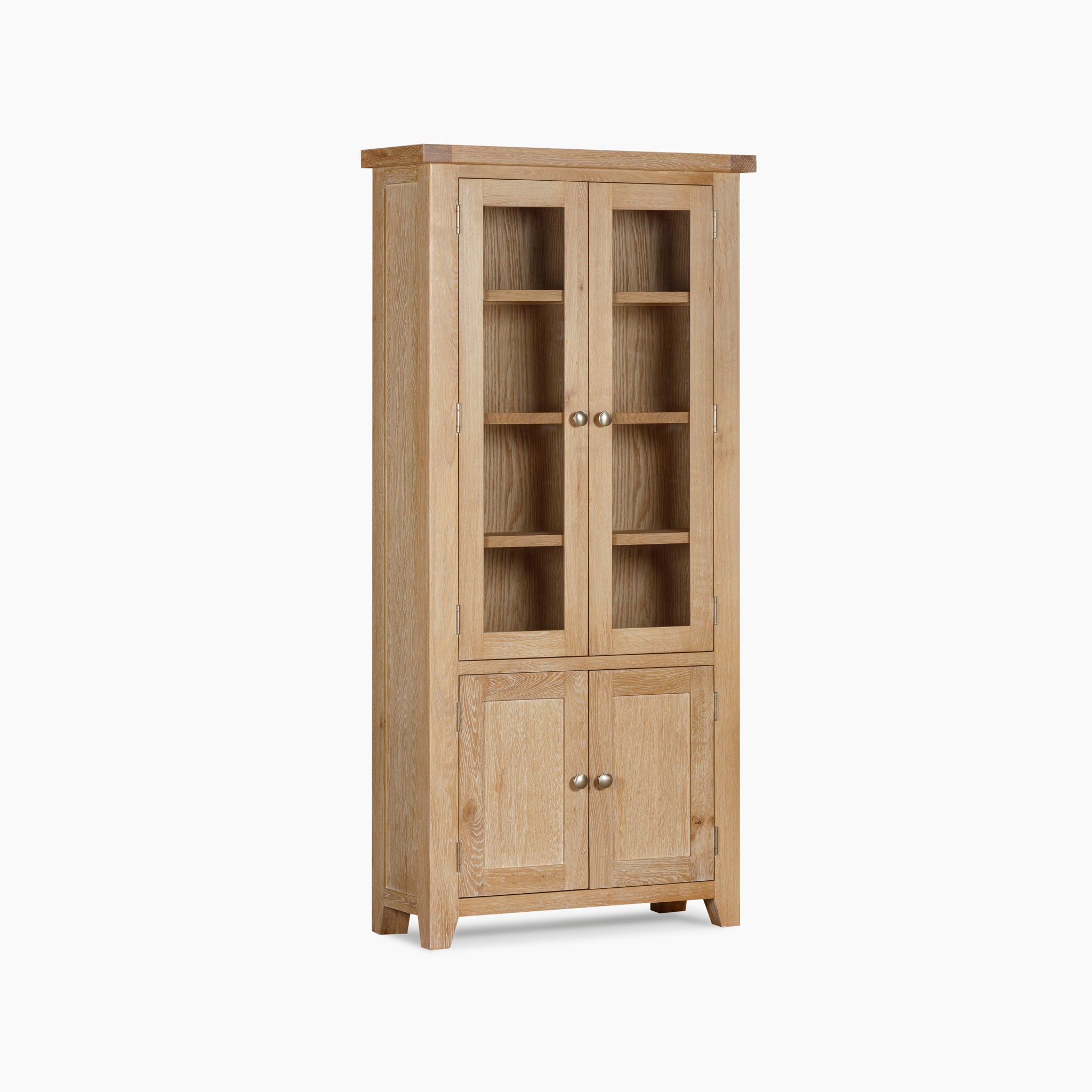 The Burford Display Cabinet in Natural Oak showcases a tall, wooden construction with two glass-paneled upper doors and two solid lower doors, each embellished with round knobs.