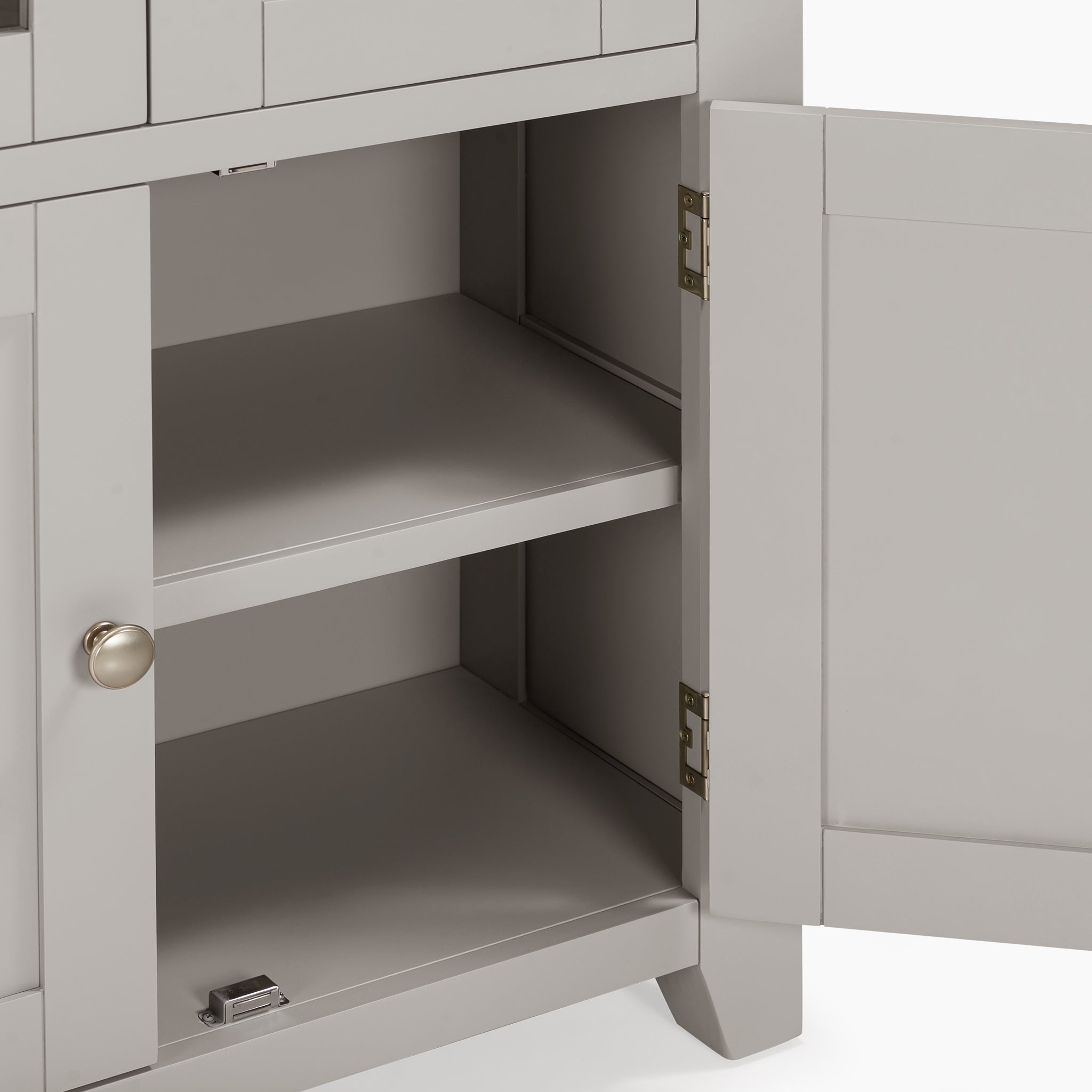 The Pebble Grey Burford Display Cabinet features an open design with two shelves and a sleek knob handle. Its glass-panelled doors are slightly ajar, giving it an elegant appearance.