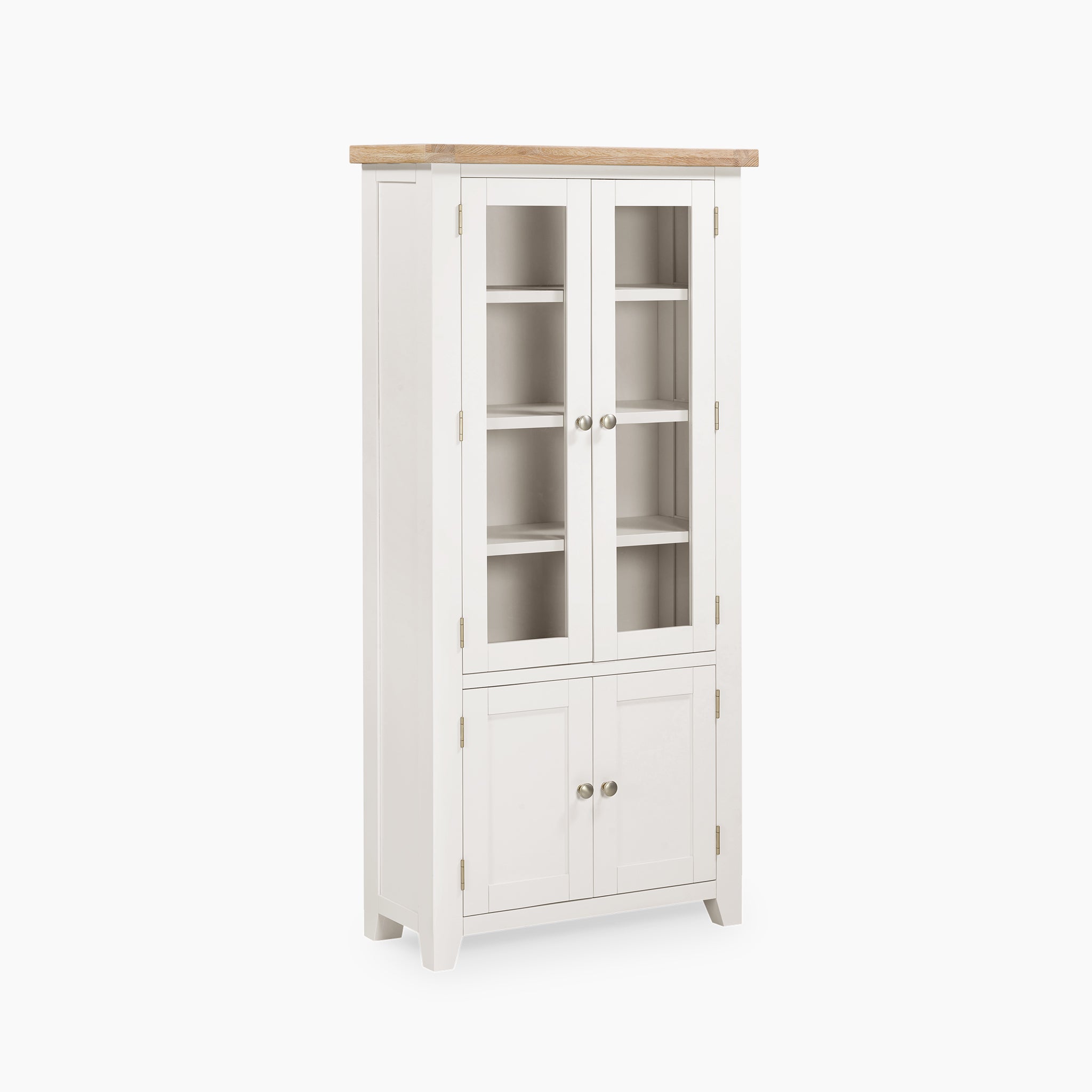 The Burford Display Cabinet in Warm White is a tall unit with natural oak accents, featuring glass-paneled top doors and a wooden top. Its two lower solid doors are adorned with round handles.