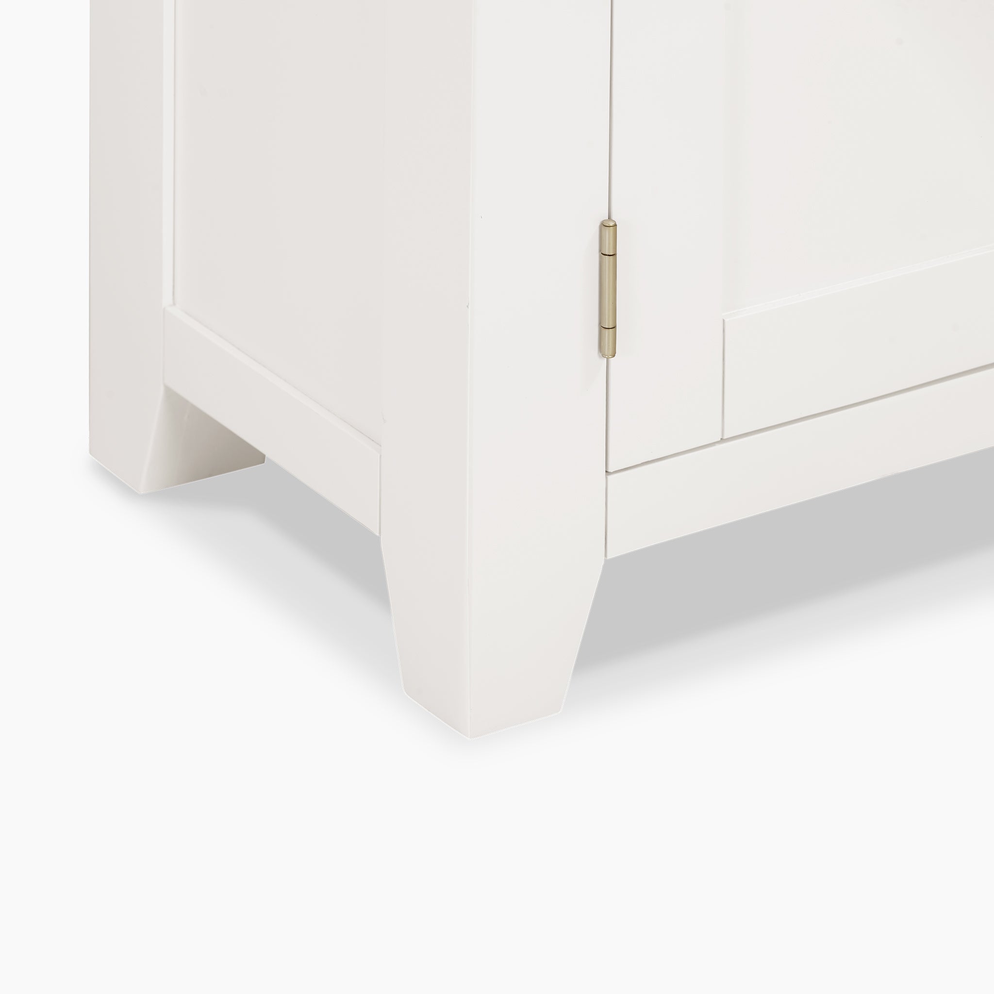 Close-up of the bottom corner of a Burford Display Cabinet in Warm White with a brass hinge.