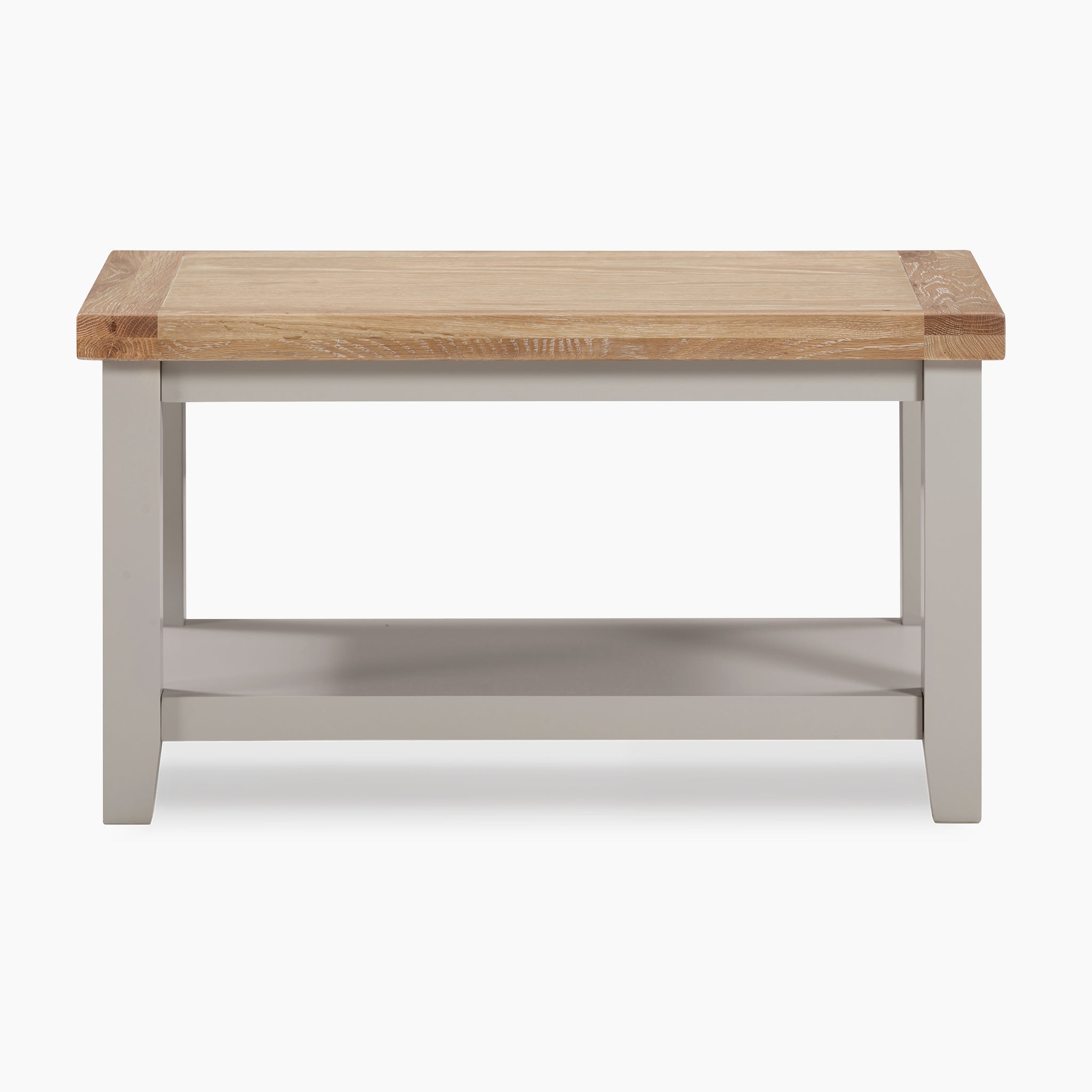 The Burford Large Coffee Table with Shelf in Pebble Grey highlights a natural oak top, complemented by pebble grey legs, and includes a convenient lower shelf.