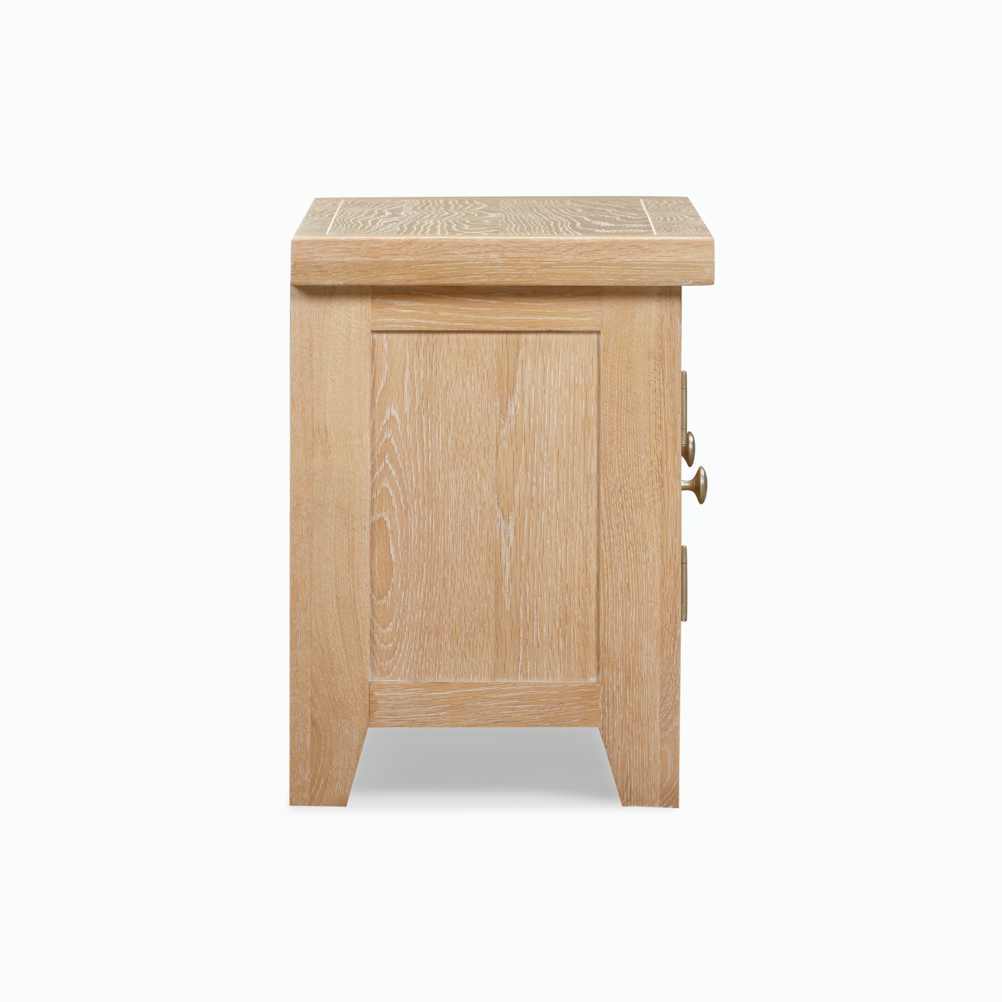 The Burford 120cm Media Unit in Natural Oak is a light wood media unit featuring a single front cabinet door with a decorative handle, all set against a white background. This piece is part of the Burford Range.