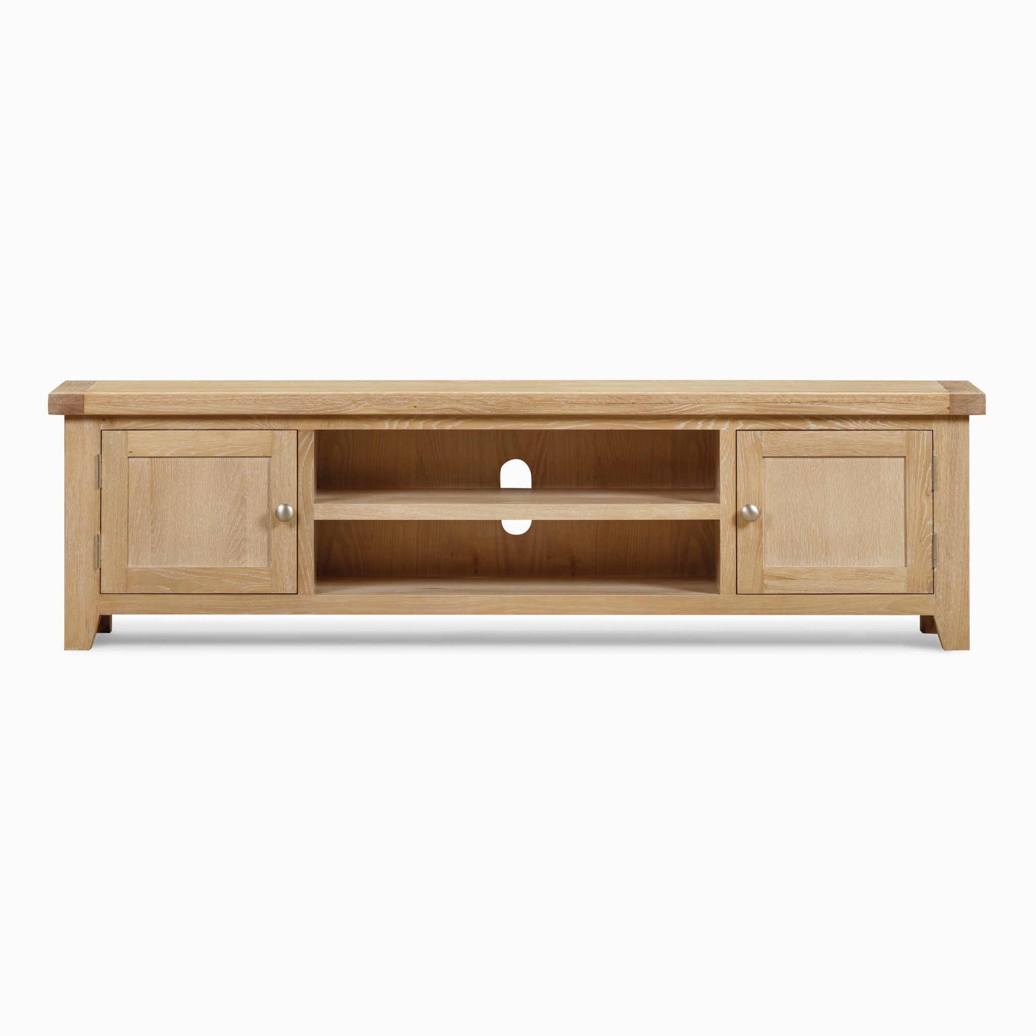 The Burford Large 180cm Media Unit in Natural Oak is a wooden TV stand that features two cabinets and two open shelves in the center. Crafted for both style and functionality, it also includes a cable management hole at the back.