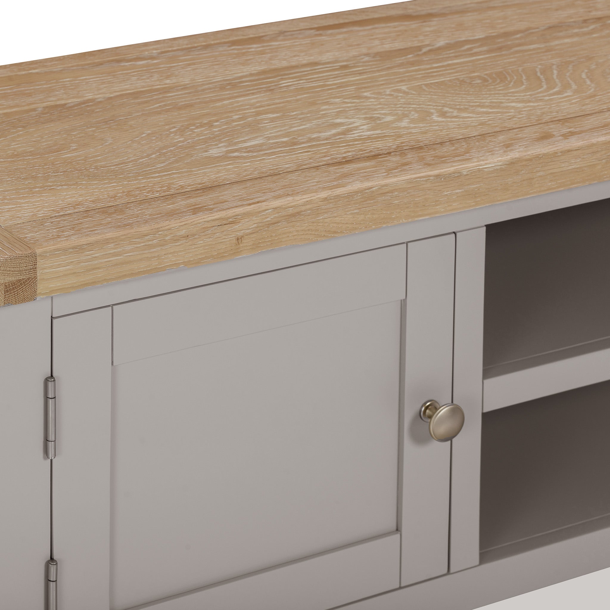 This elegant Burford Large 180cm Media Unit in Pebble Grey features a natural oak wooden top. The cabinet door is adorned with a metallic knob, adding a touch of sophistication.