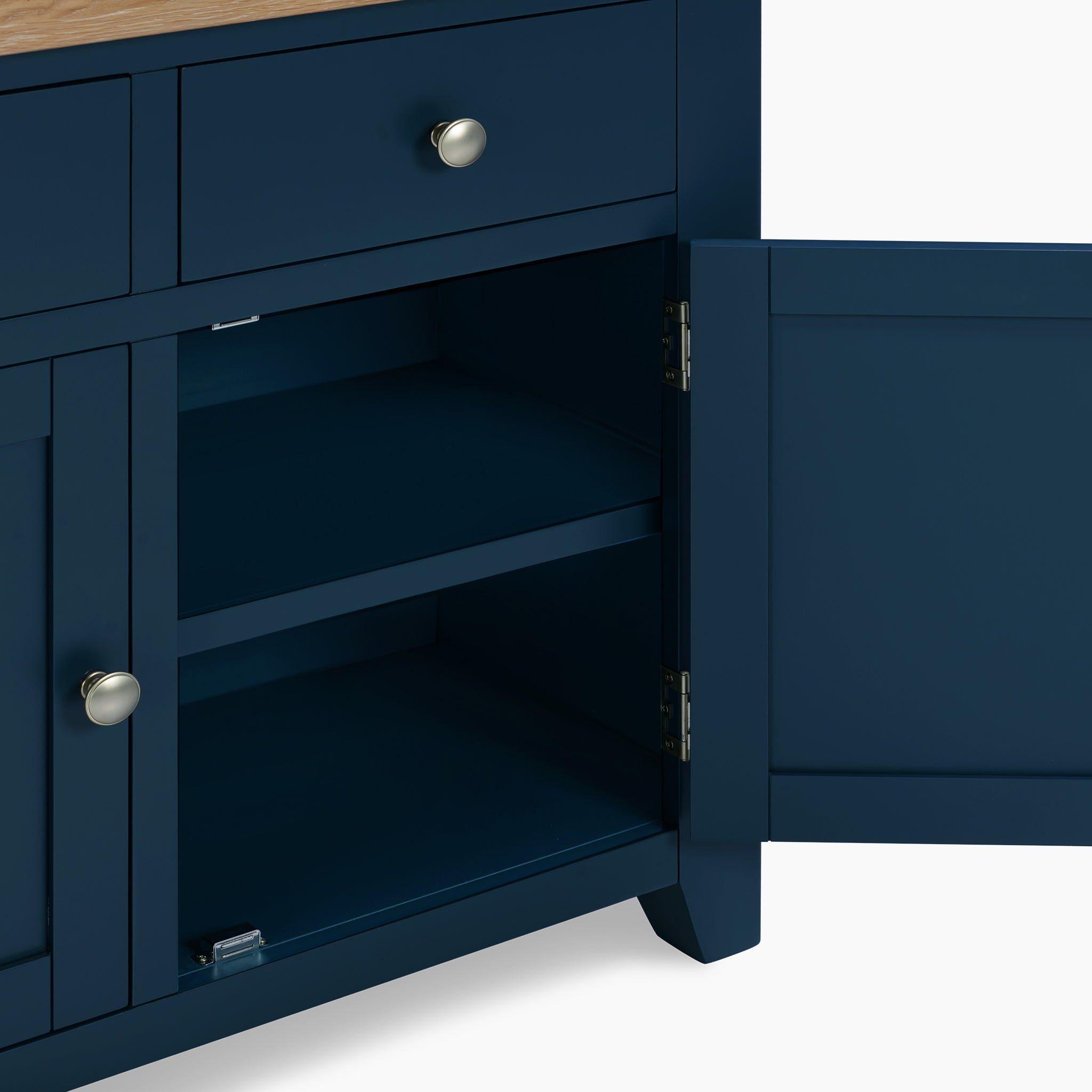 Open the navy blue Burford 2 Door 2 Drawers Sideboard, featuring a silver knob and two interior shelves that beautifully complement its natural oak finish.