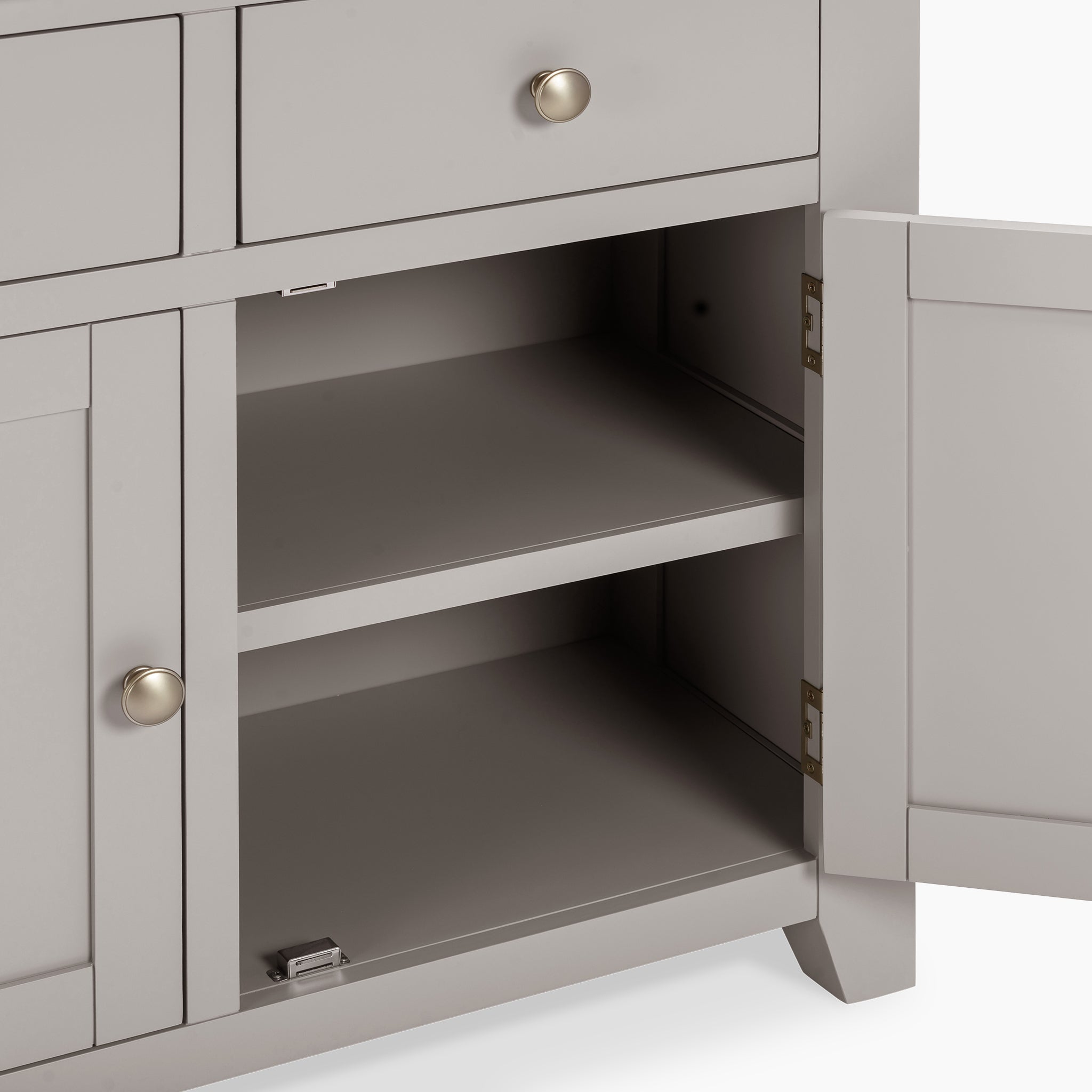 The Burford 2 Door 2 Drawers Sideboard in Pebble Grey showcases an open cabinet with two shelves and round handles on its doors and drawers, expertly combining functionality with style.