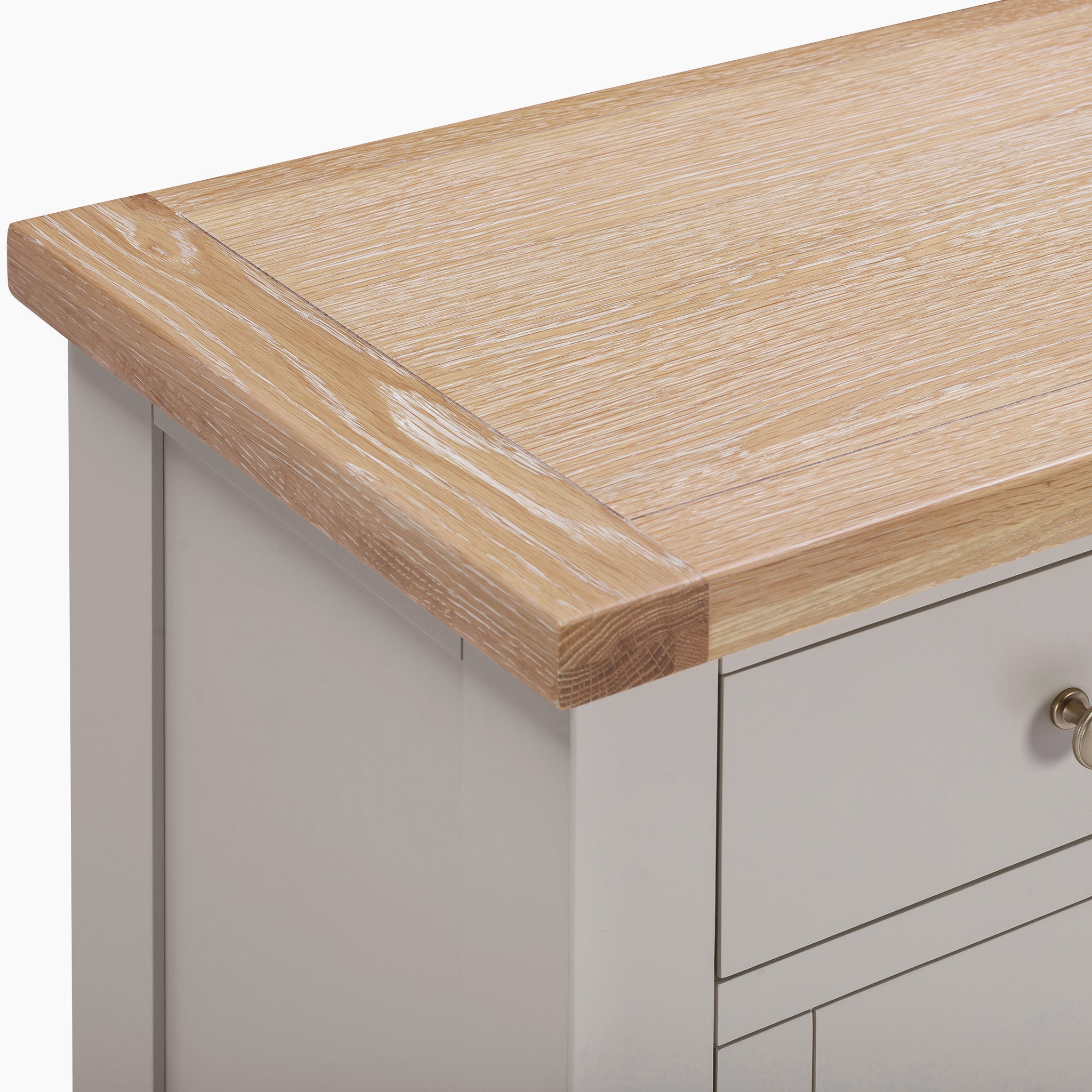 Natural oak sideboard with a light-colored top and Pebble Grey drawers, featuring sleek metal handles.