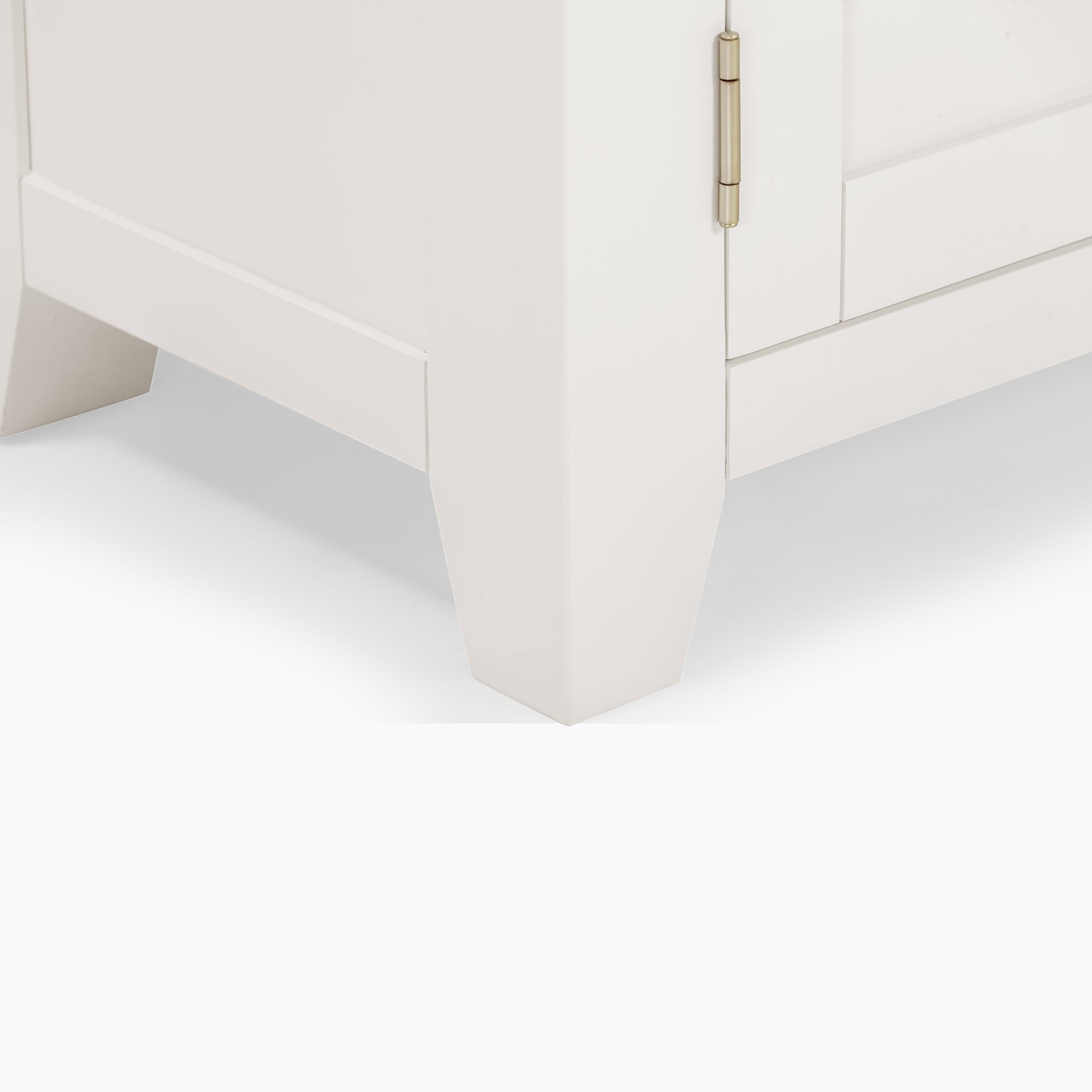 A close-up of the Burford 2 Door 2 Drawers Sideboard in Warm White, showcasing its corner with a door hinge and tapered legs, set against a white backdrop.