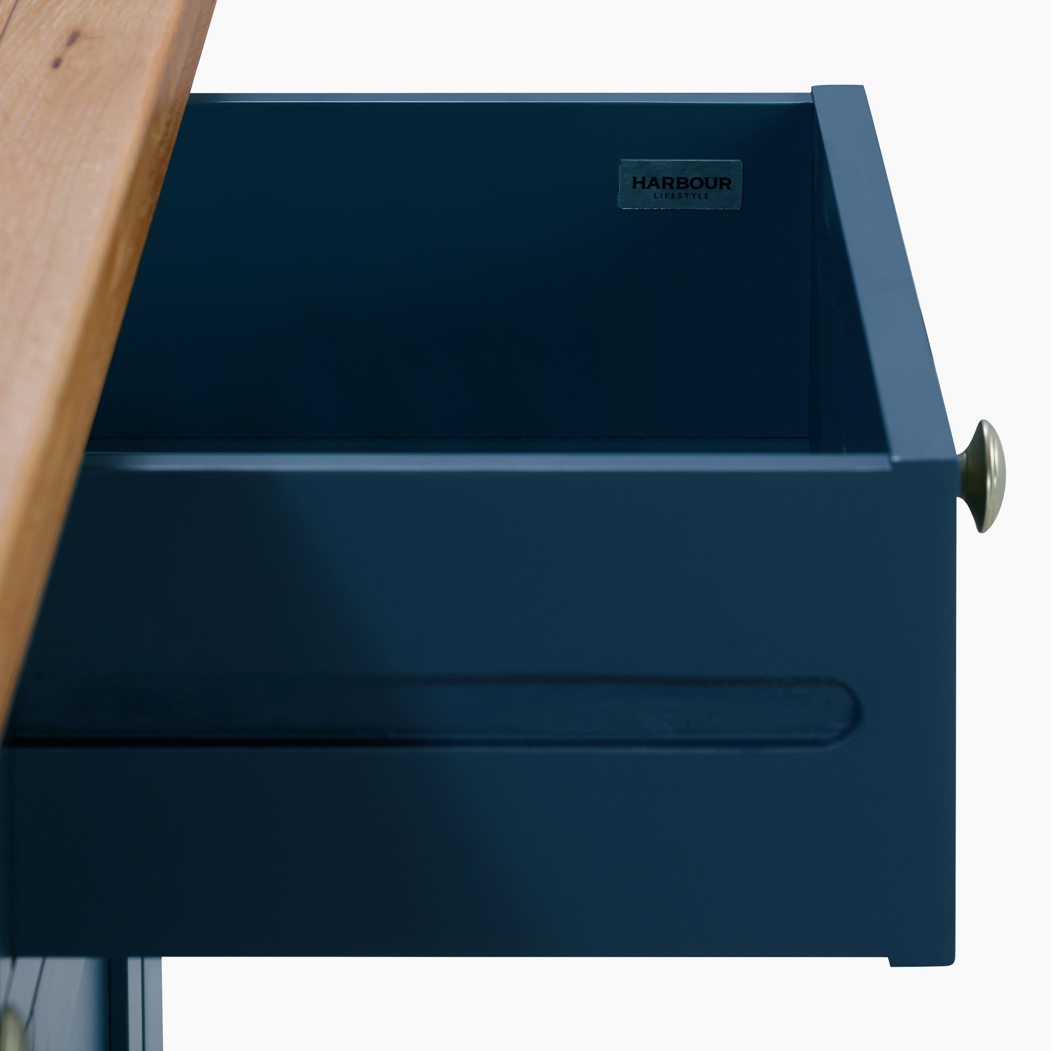 Open navy blue drawer with a brass knob, slightly extended from the premium natural oak top of a Burford Large 3 Door 3 Drawers Sideboard in Navy Blue.