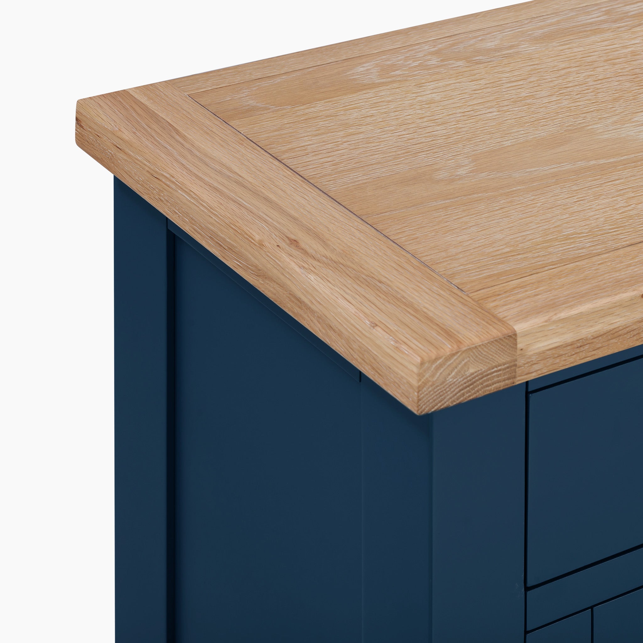 Corner perspective of a navy blue Burford Large 3 Door 3 Drawers Sideboard with a premium natural oak top.