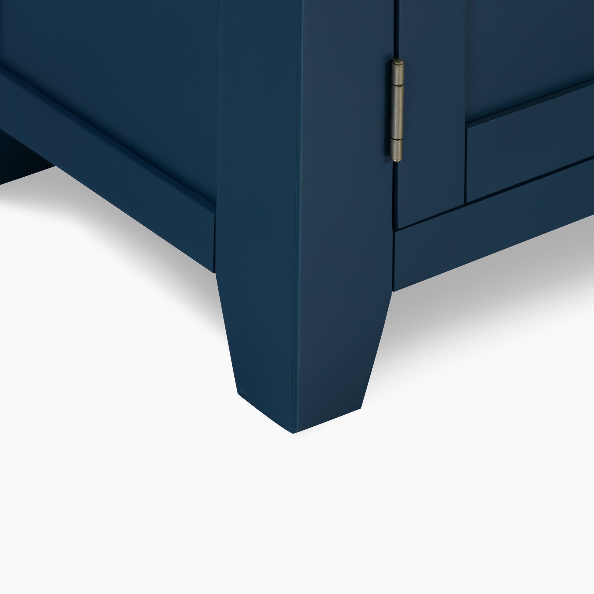 Close-up of a corner of the Burford Large 3 Door 3 Drawers Sideboard in navy blue, showcasing a visible hinge that elegantly contrasts against the premium natural oak finish and white background.