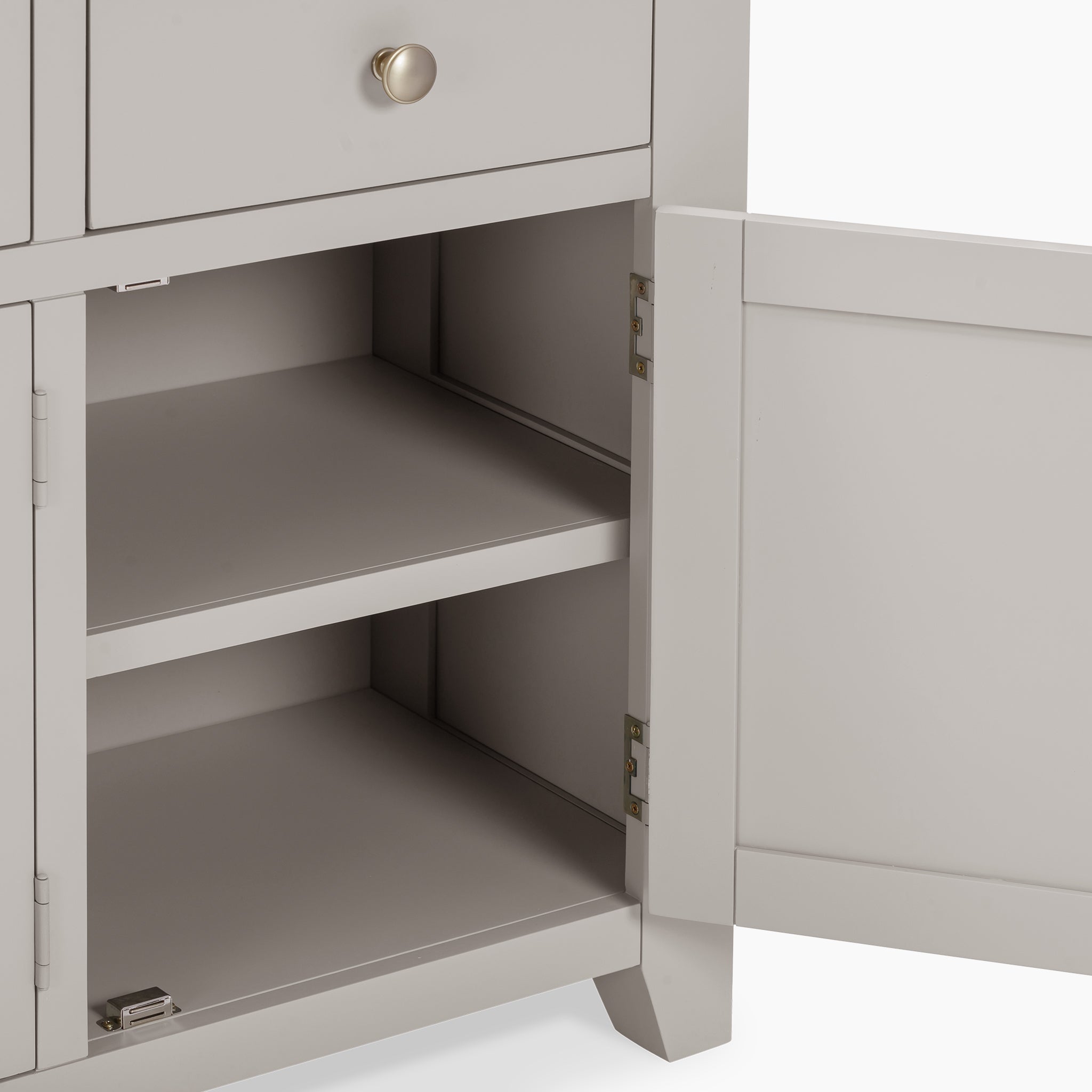 A Pebble Grey cabinet with one door open reveals two empty shelves inside, reminiscent of the natural oak finish found in the elegant Burford Large 3 Door 3 Drawers Sideboard.