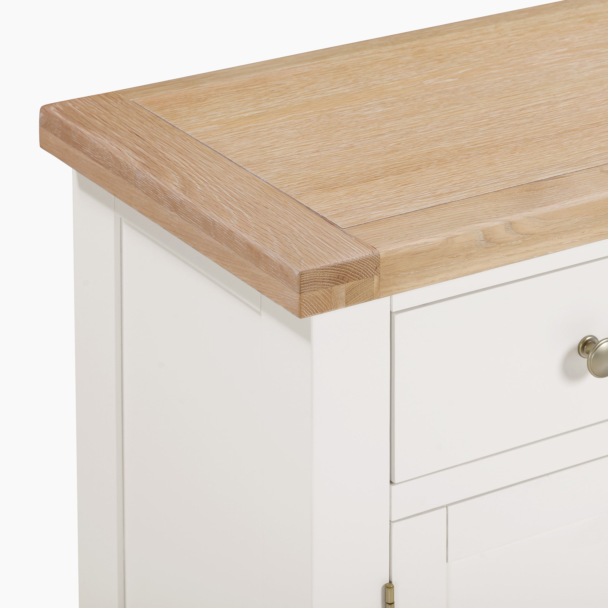 Close-up of the Burford Large 3 Door 3 Drawers Sideboard in Warm White, showcasing a white cabinet paired with a light natural oak top and metal knobs on the drawers, ideal for adding stylish storage to any room.