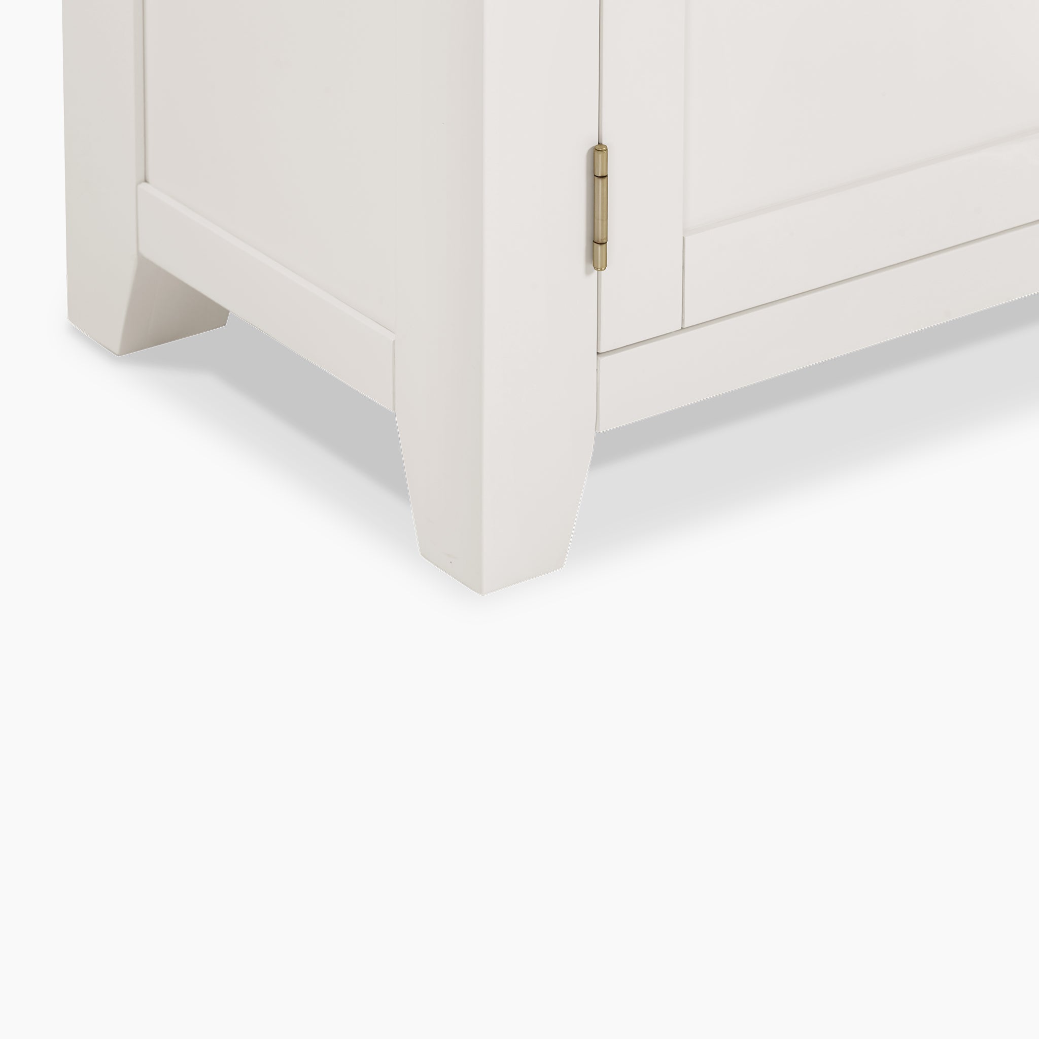 Close-up of the Burford Large 3 Door 3 Drawers Sideboard in Warm White, highlighting its door's metal hinge, corner design, and leg structure, combining style with generous storage.