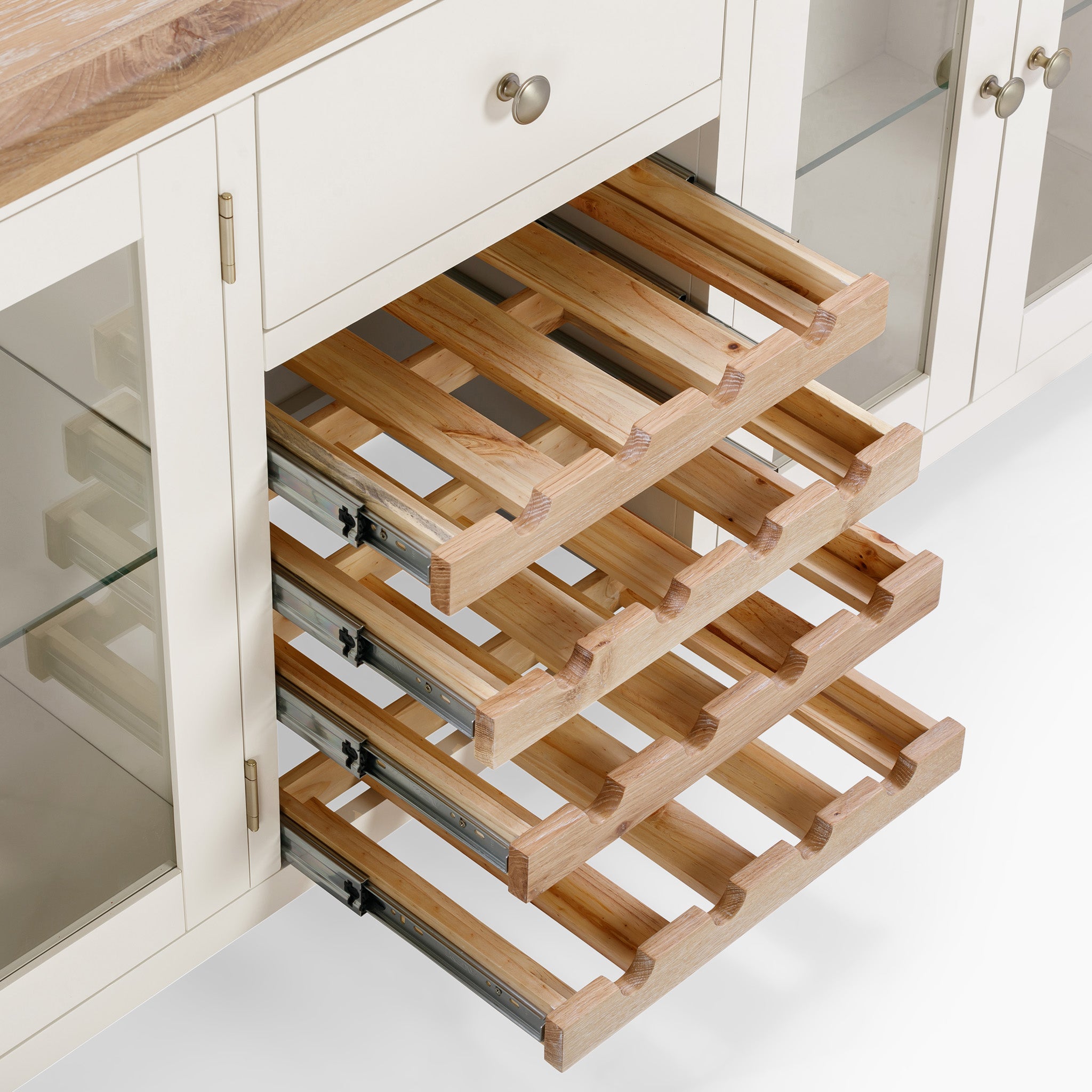 Warm white Burford Grand Sideboard cabinet with wine rack drawers partially pulled out.