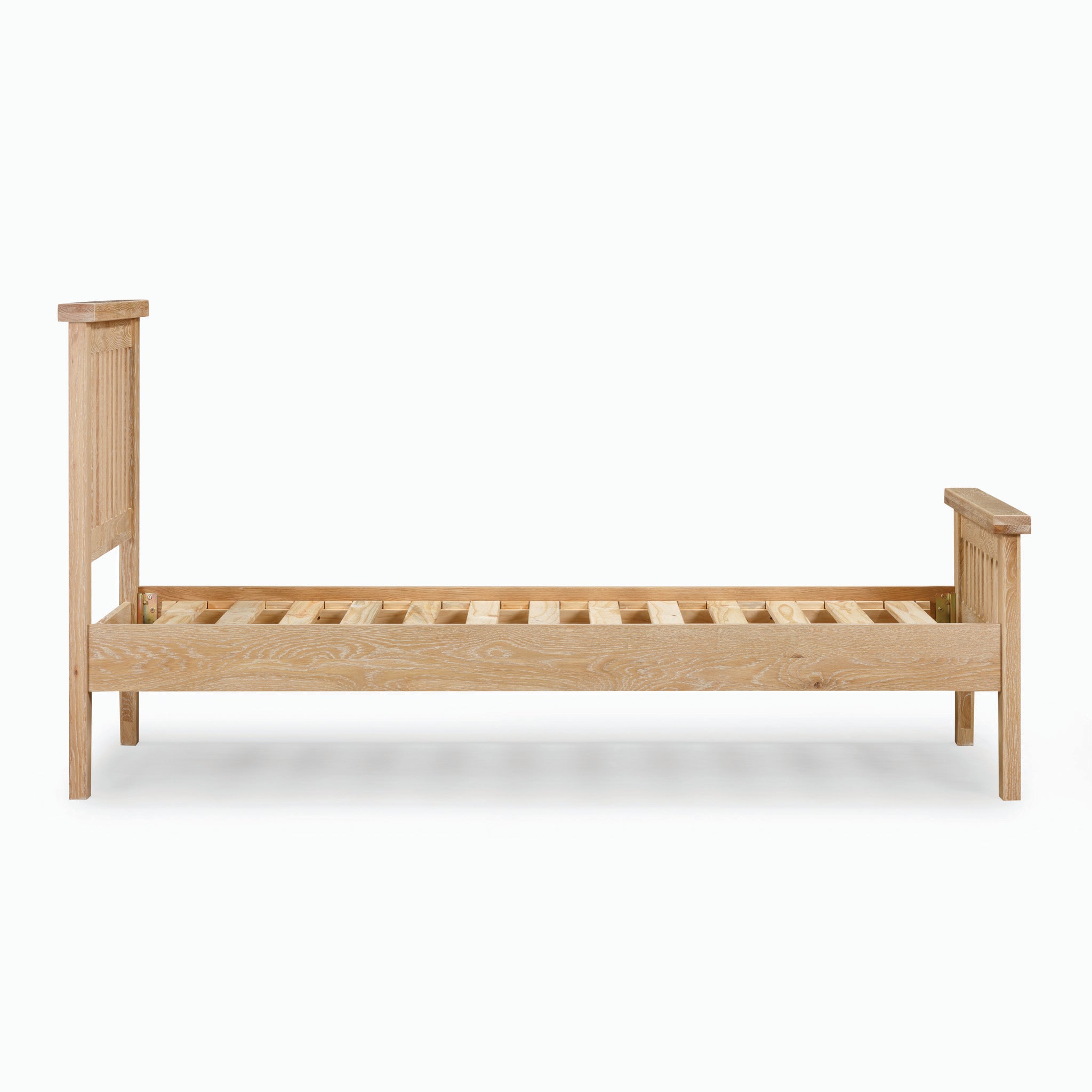 The Burford 3ft High-End Single Bed Frame in Natural Oak boasts a simple design with both a headboard and footboard. Set against a white background, this single wooden bed frame elegantly highlights its timeless charm.