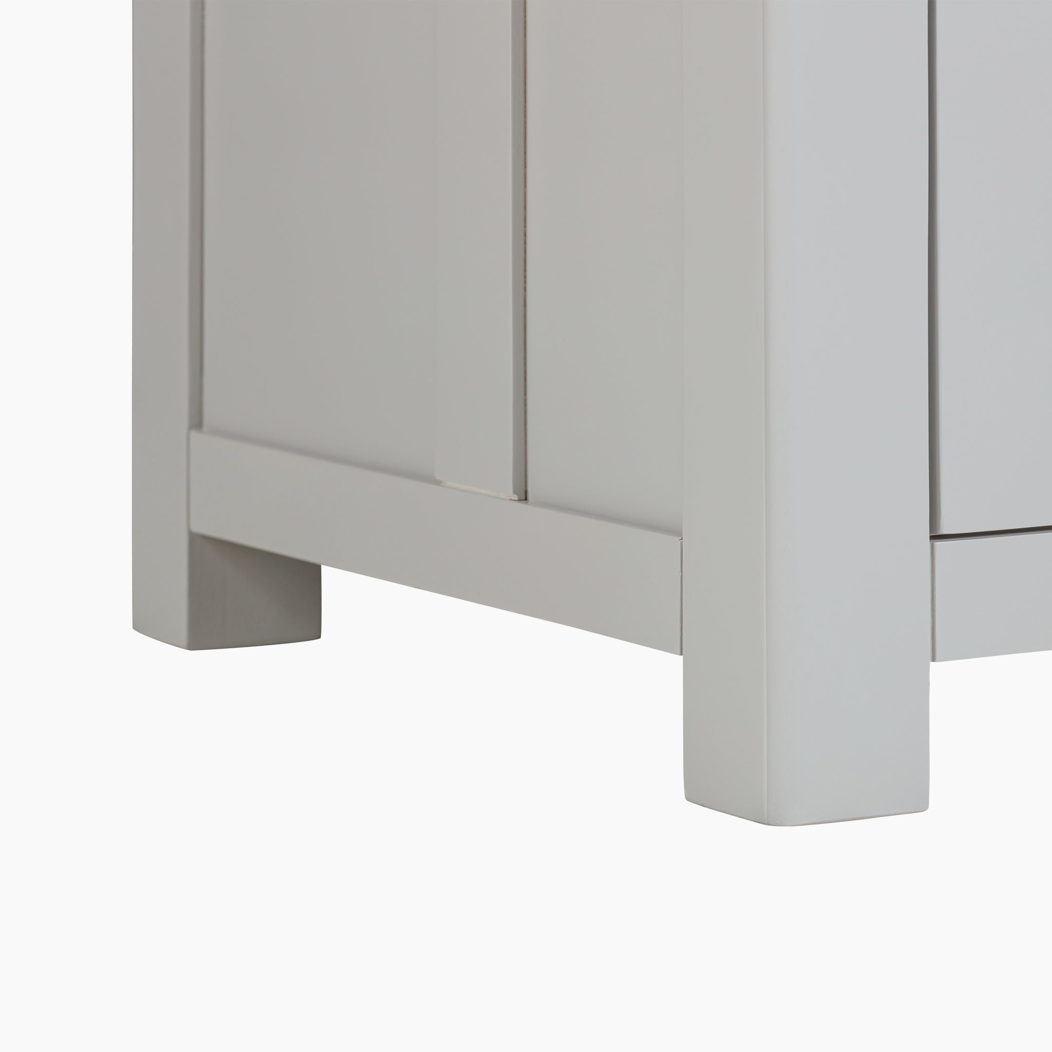 Close-up of the bottom corner of a Burford Single Larder Unit in Pebble Grey, featuring a simple panel design that integrates effortlessly into the kitchen storage.