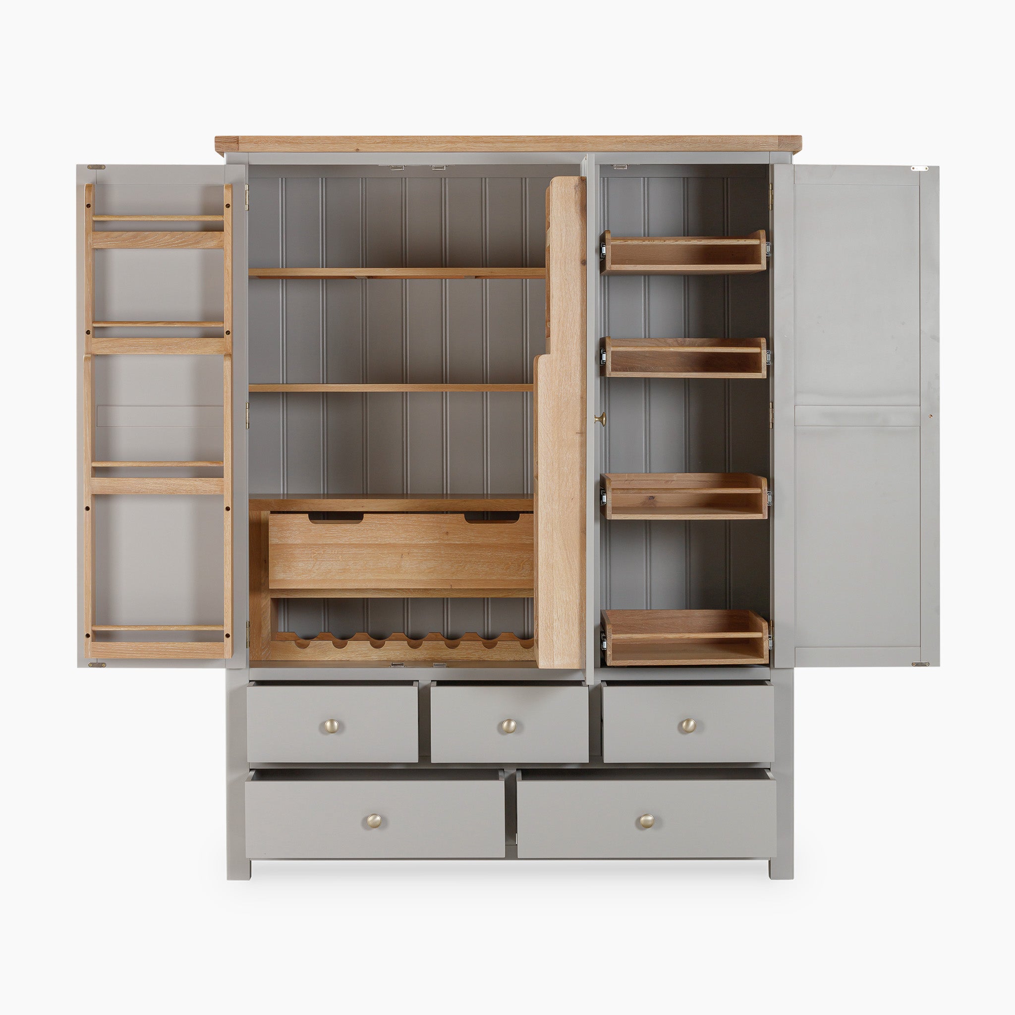 The Burford Triple Larder Unit in Pebble Grey showcases an open cabinet design with natural oak shelves, a wine rack, and bottom drawers, providing sophisticated storage solutions for the kitchen.