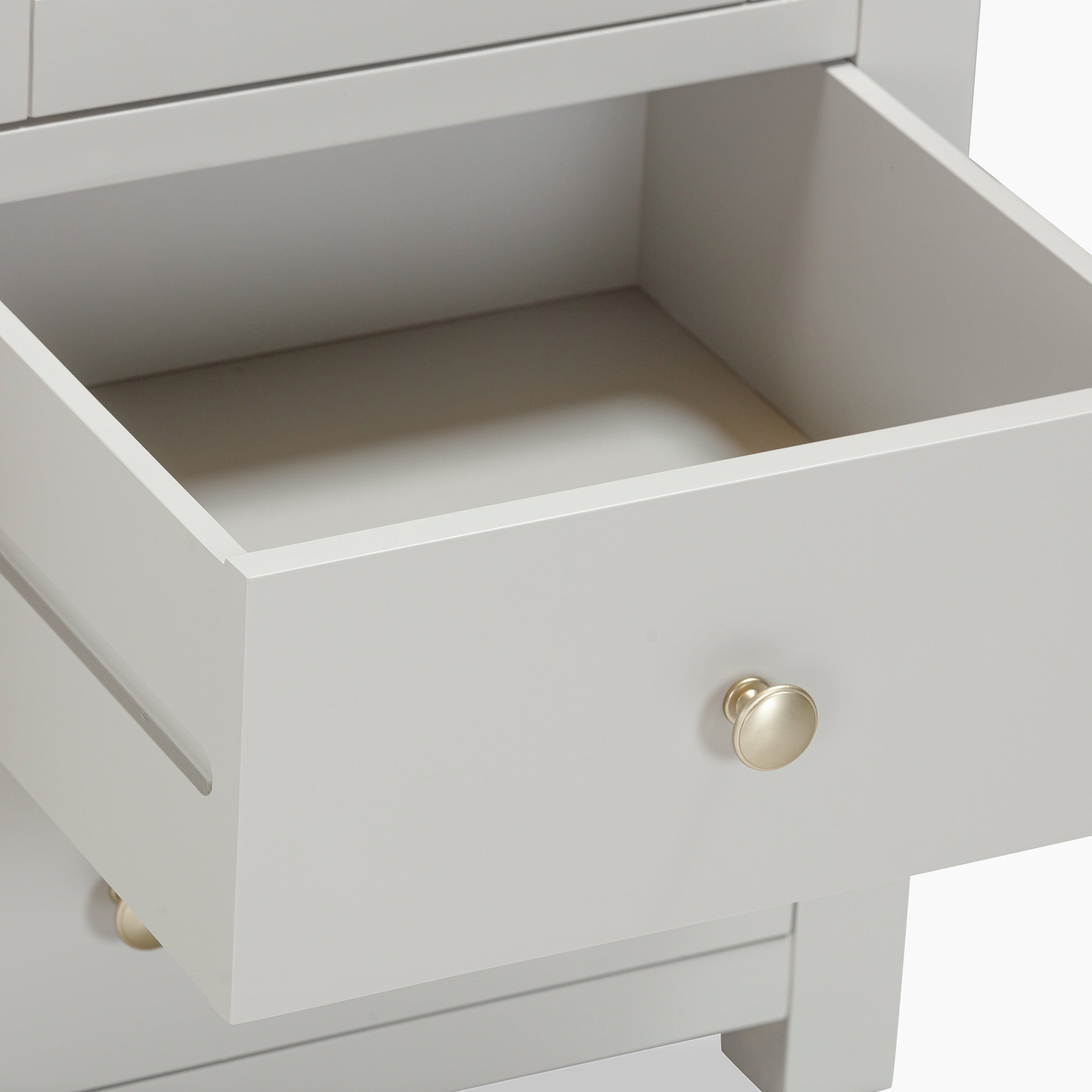 Open the drawer of the stylish Burford Triple Larder Unit, a pebble grey cabinet adorned with a round golden knob, offering exquisite kitchen storage solutions.