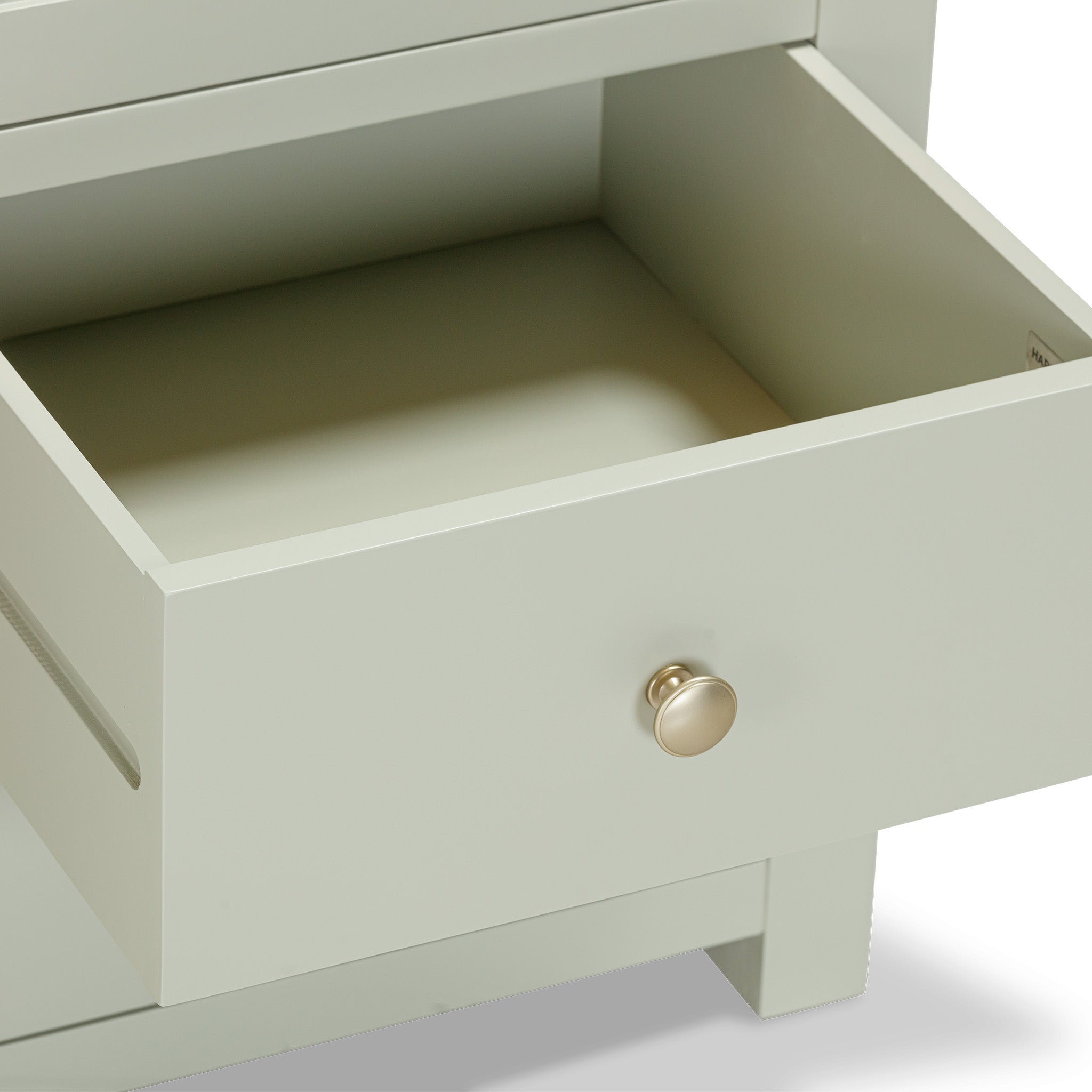 A partially open drawer with a round knob on the sage green Burford Triple Larder Unit.