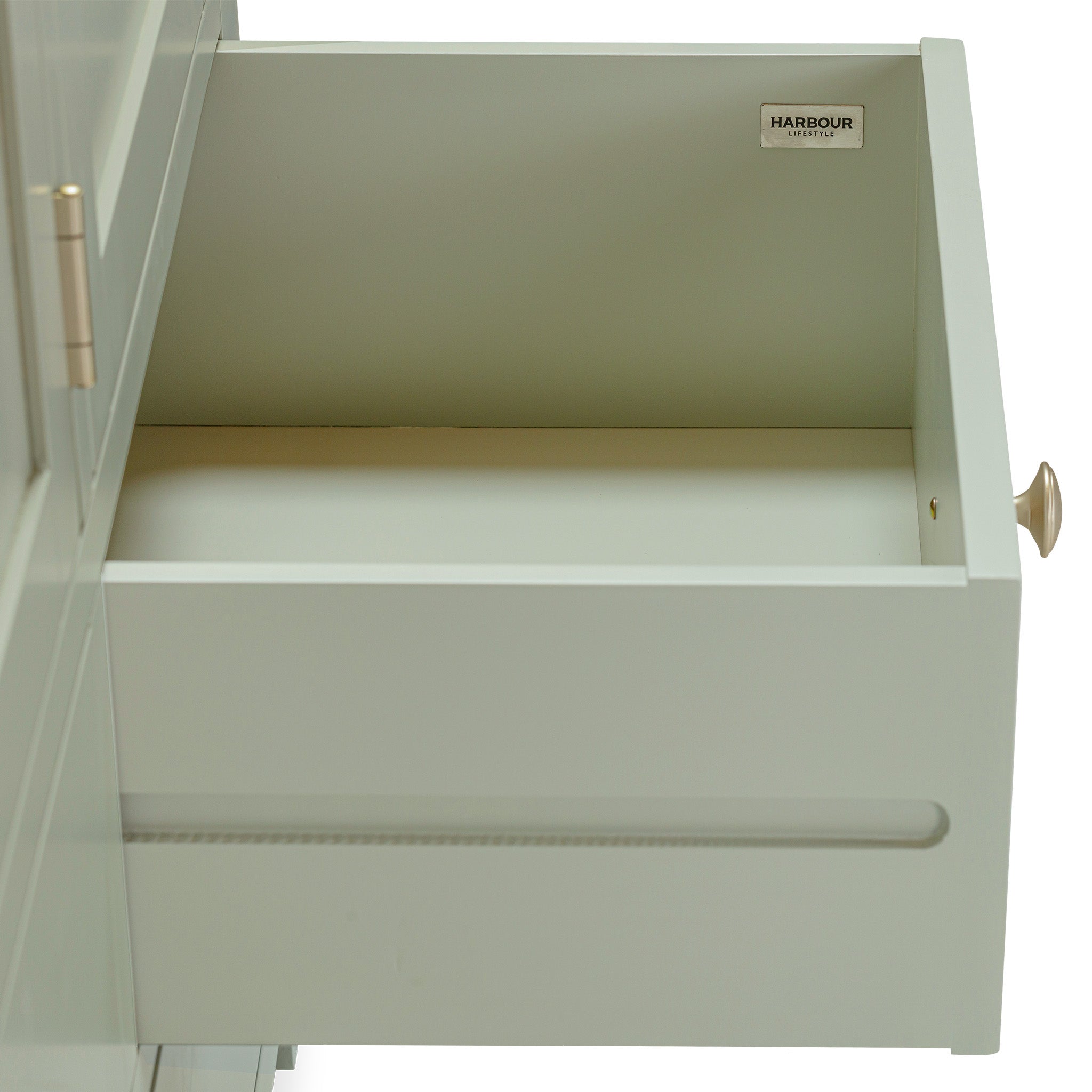 An open drawer with a small knob, labeled "Harbour," showcases the allure of the Burford Triple Larder Unit in Sage Green, ideal for improving kitchen storage.