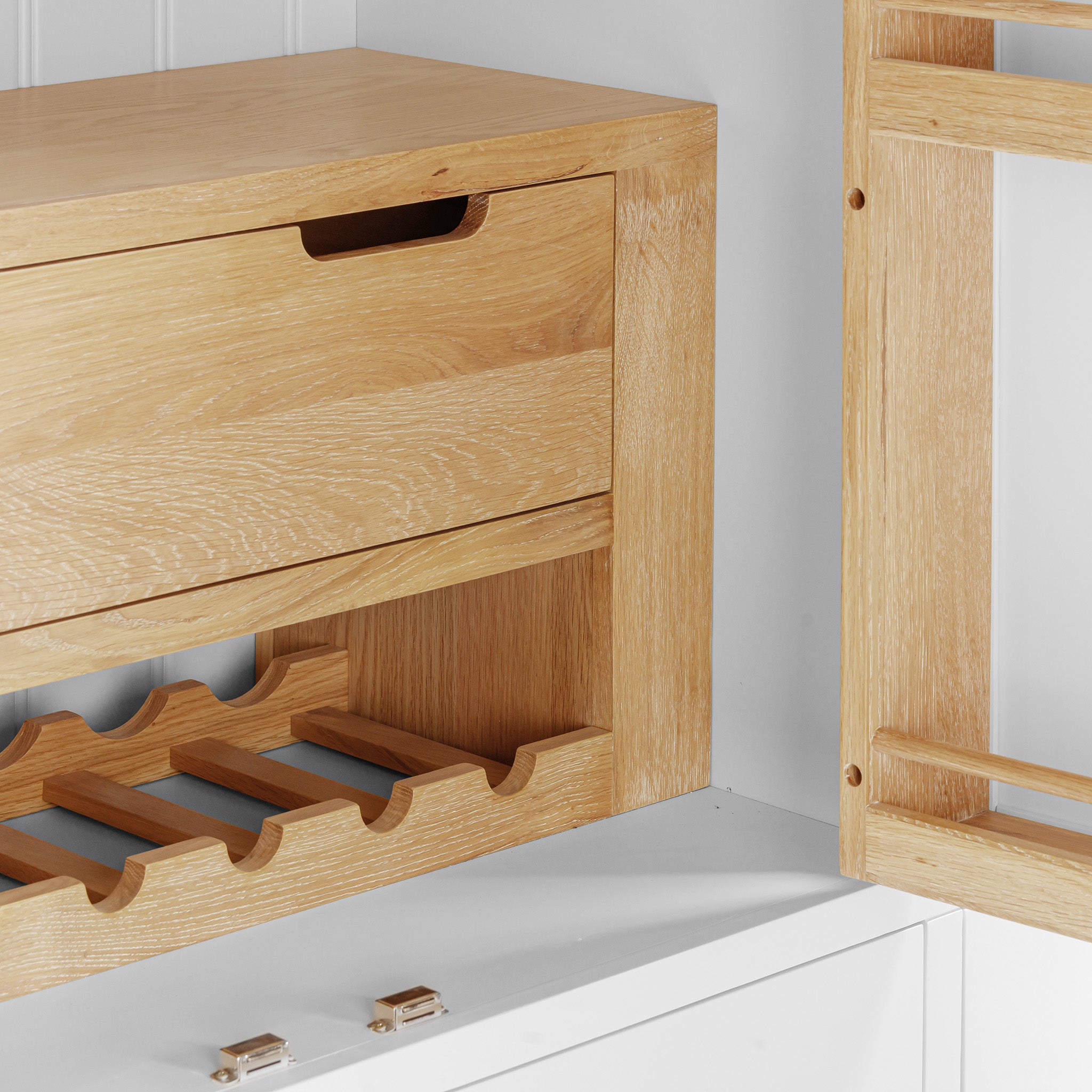 The Burford Triple Larder Unit in Warm White is a versatile storage solution, boasting wooden cabinetry with drawers and an integrated wine rack.