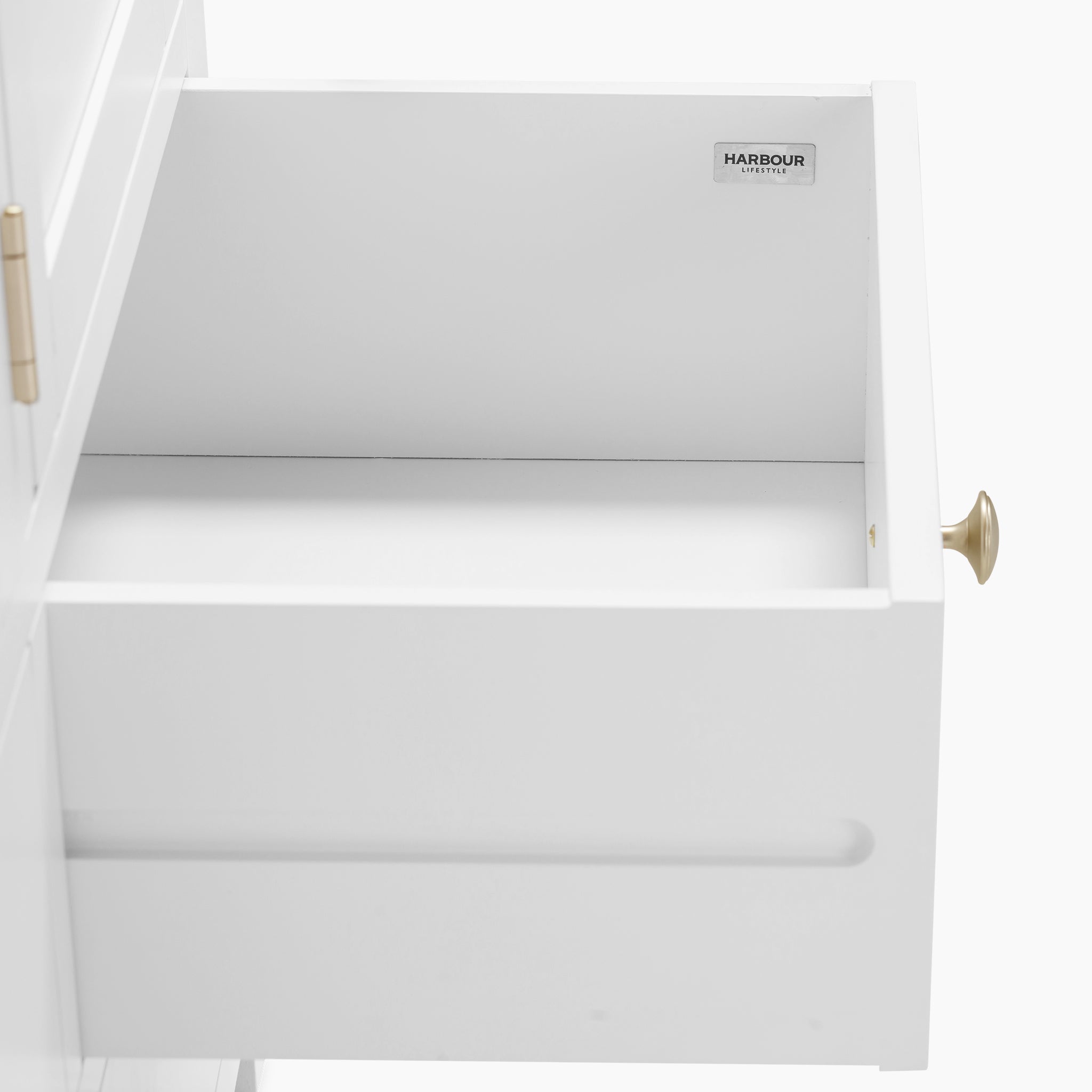 The Burford Triple Larder Unit in Warm White features an open drawer equipped with a brass handle. The interior includes a small "Harbour" label in the upper left corner, making it a versatile storage solution perfect for kitchen larders.