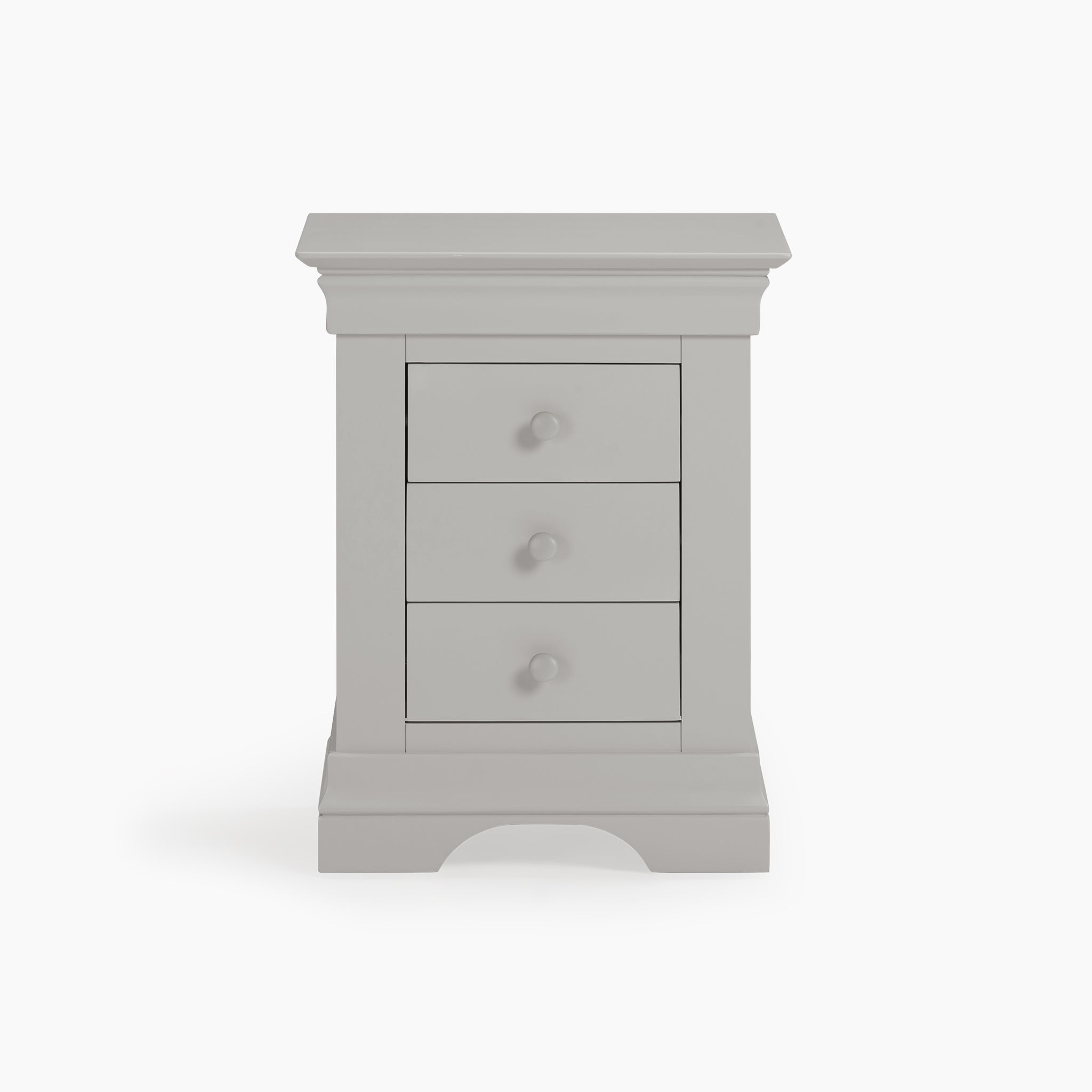 The Chalbury 3 Drawer Bedside Table in Pebble Grey showcases a classic design with understated knobs. This elegant piece, isolated on a white background, is perfect for any bedroom setting and highlights its timeless appeal.