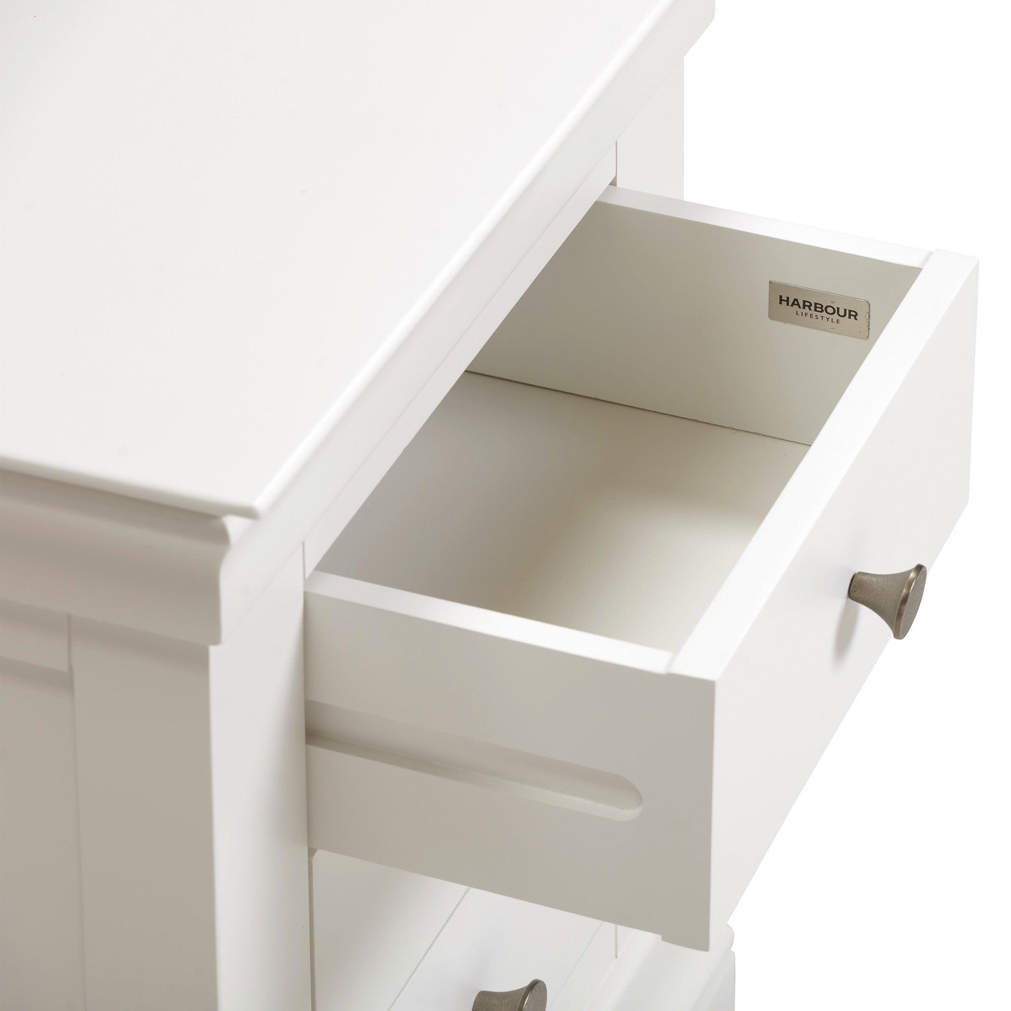 The Chalbury 3 Drawer Bedside Table in Warm White is an ideal enhancement to your bedroom décor, showcasing a stylish design with three drawers and elegant metallic handles.