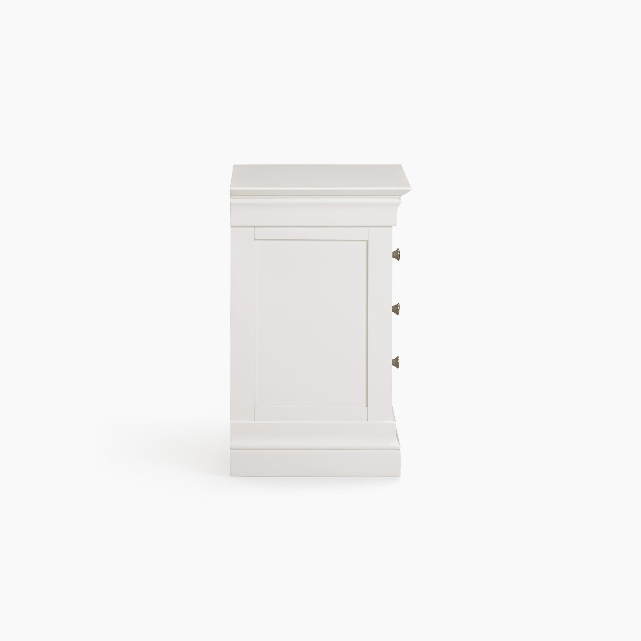 Side view of the Chalbury 3 Drawer Bedside Table in Warm White, featuring metal handles, enhancing the bedroom décor against a plain background.