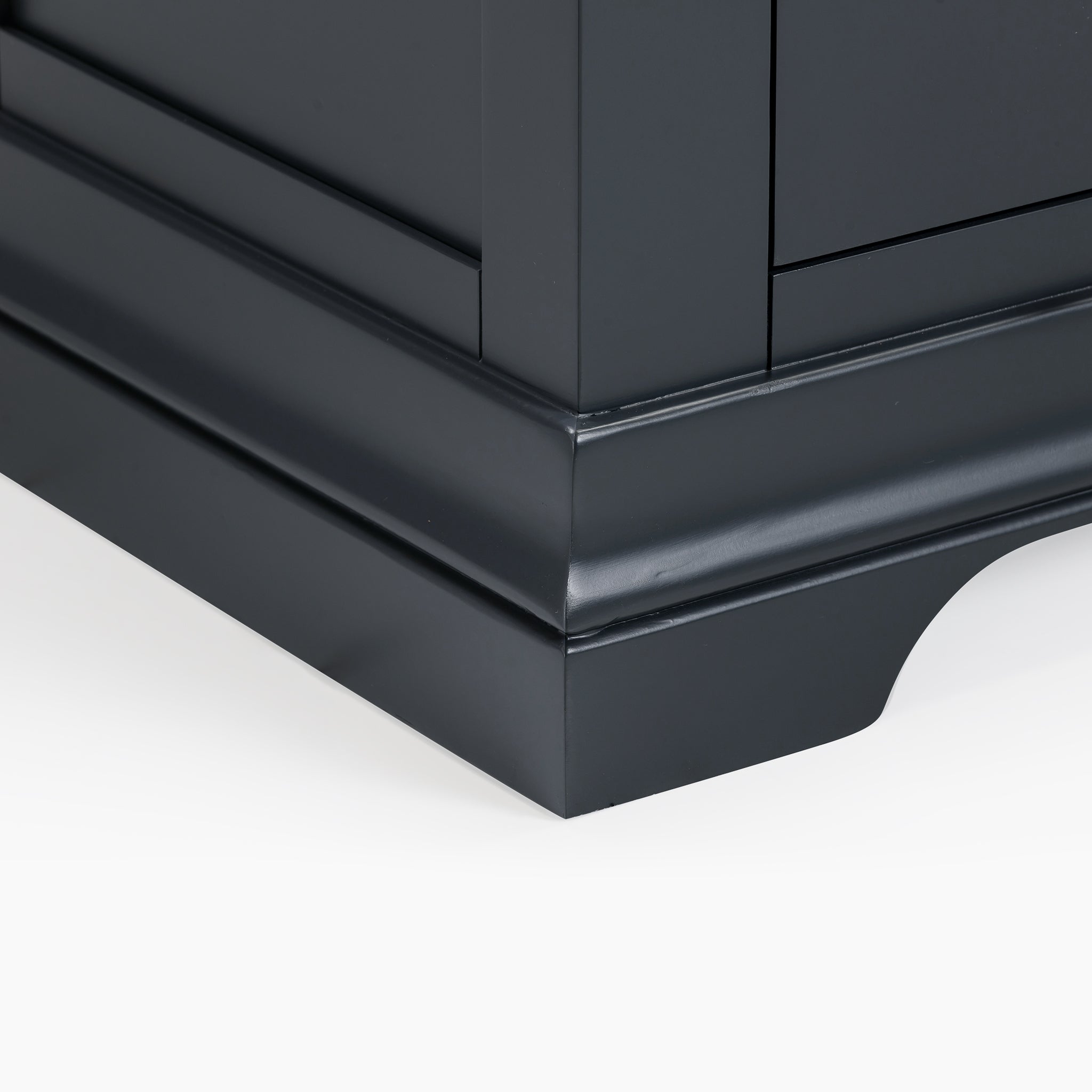 Close-up of the Chalbury 2 Over 3 Chest of Drawers in Dusky Black base highlights its decorative molding and arch detail against a white background, exemplifying a seamless fusion of classic craftsmanship and modern design.