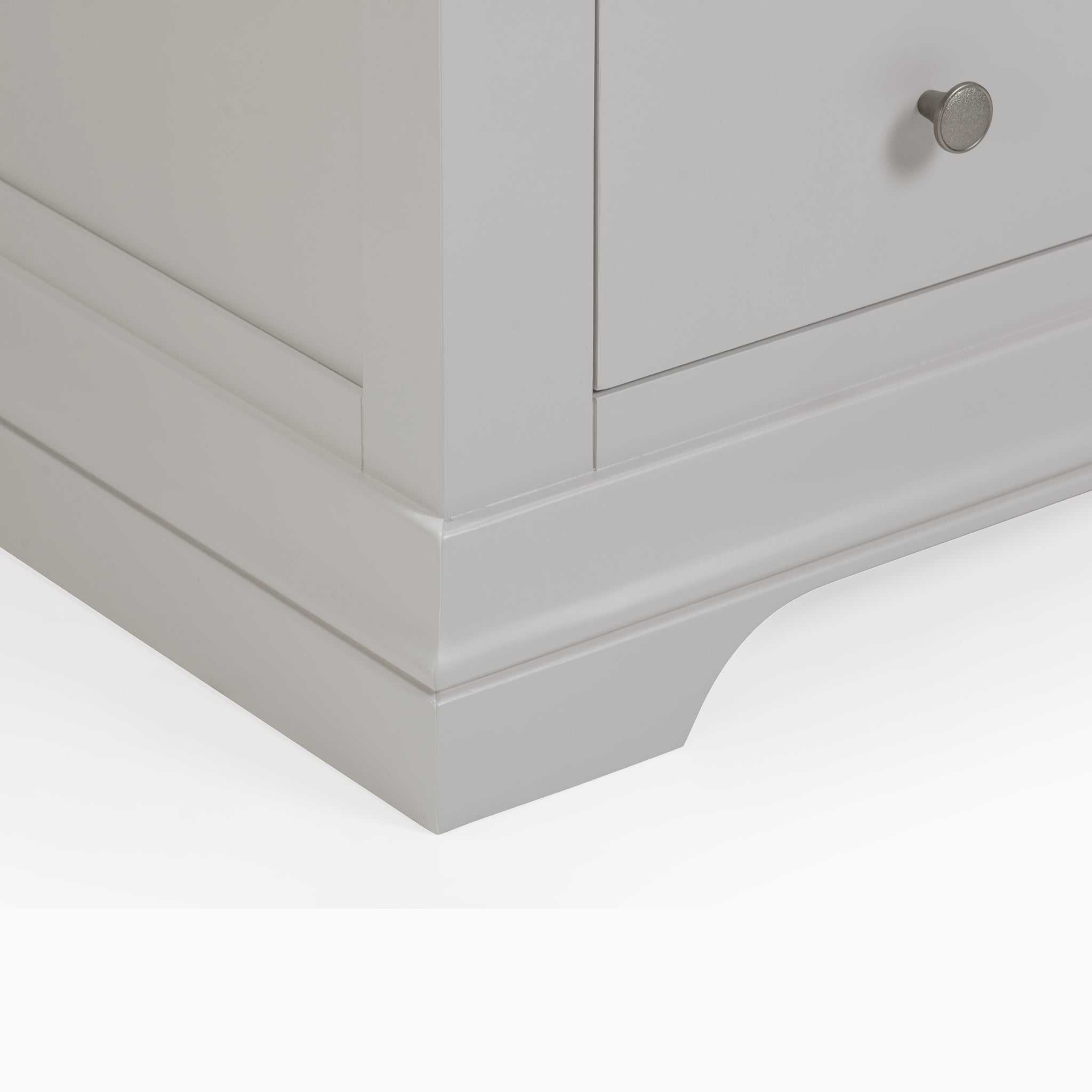 Close-up of a modern Chalbury 2 Over 3 Chest of Drawers in Pebble Grey highlighted by a small round metal knob on the drawer.