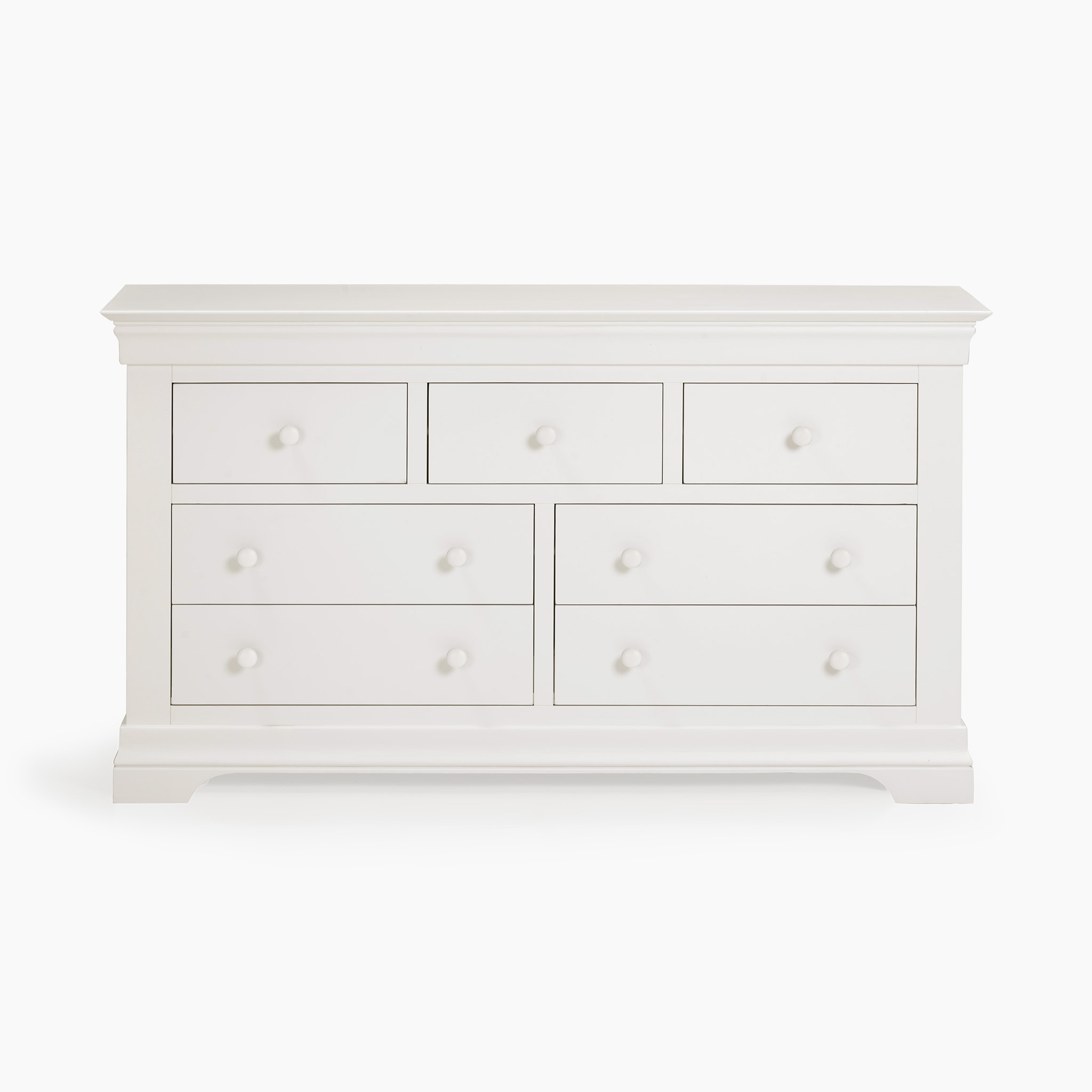 The Chalbury 3 Over 4 Chest of Drawers in Warm White is an elegant piece of storage furniture, boasting seven spacious drawers and round knobs.