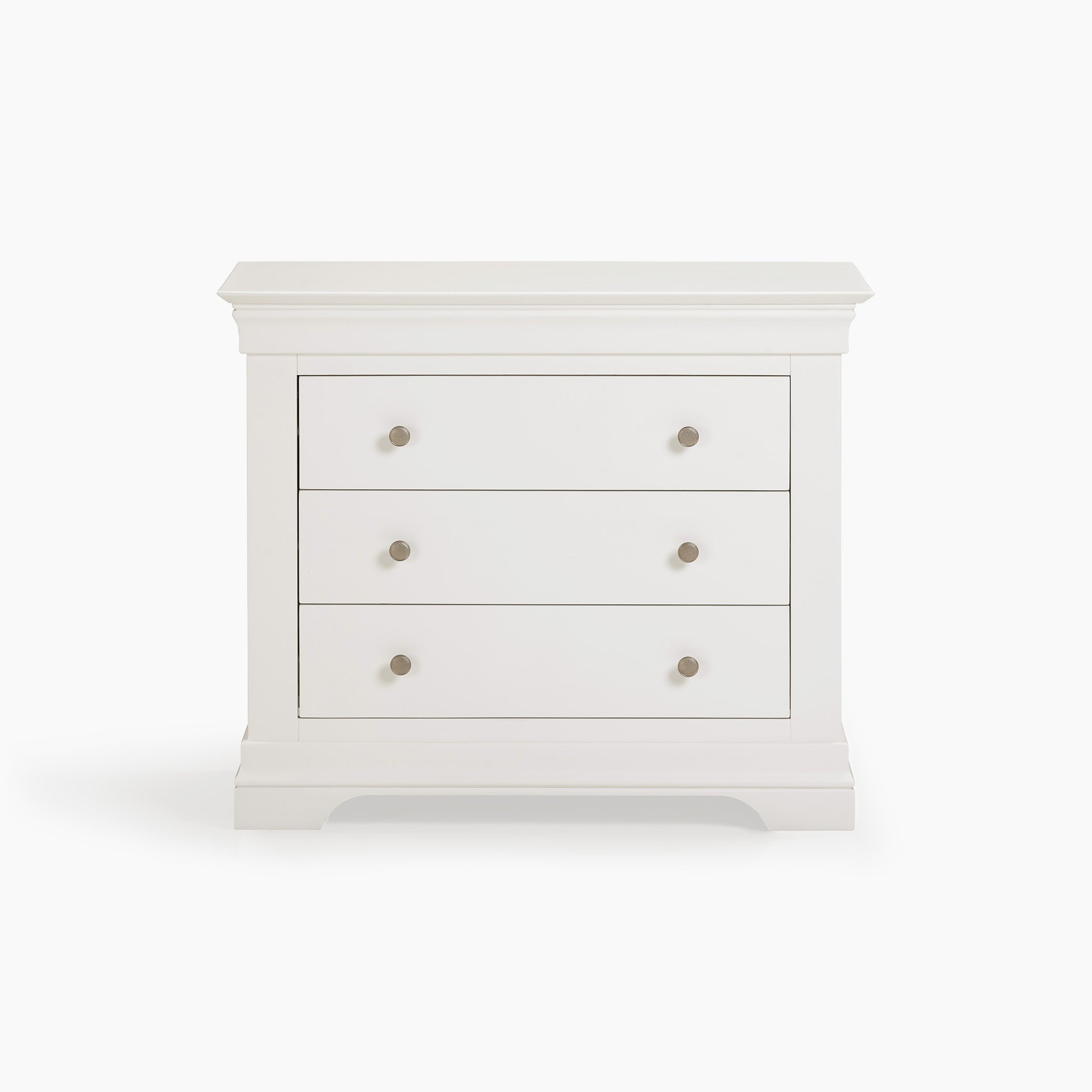 The Chalbury 3 Drawer Chest in Warm White provides generous storage capacity and boasts a modern design with round handles set against a simple backdrop.