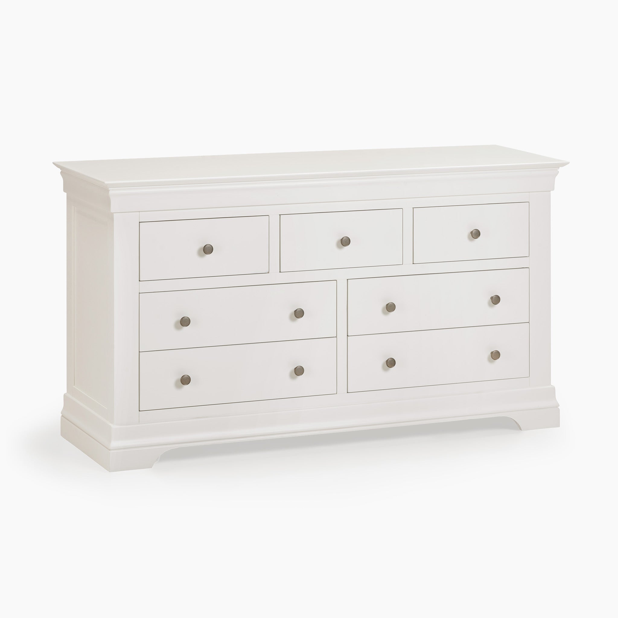 The Chalbury 3 Over 4 Chest of Drawers in Warm White is an elegant storage piece, showcasing a plain white finish with seven drawers and round handles, blending style with practicality.