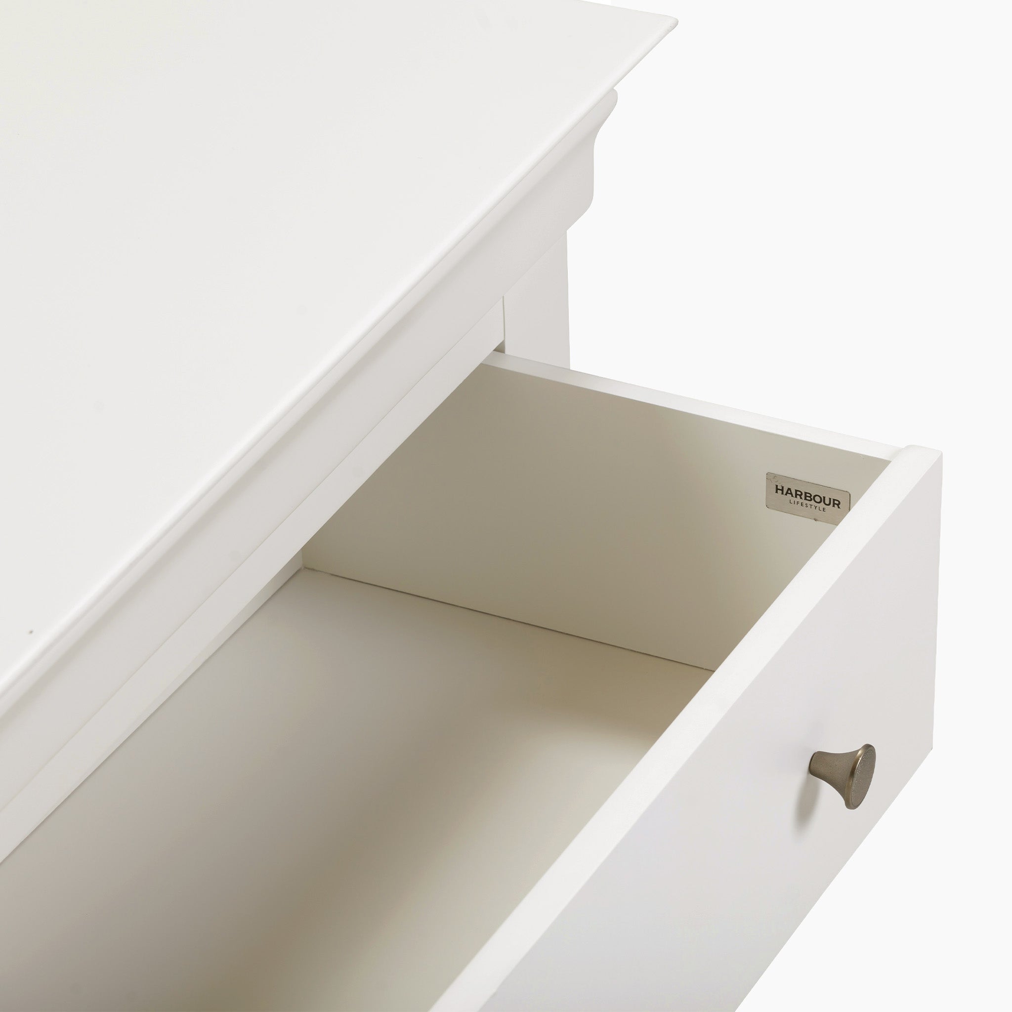 Open the drawer with a wood knob and "Harbour Housewares" label inside, from the Chalbury 3 Drawer Chest in Warm White collection.