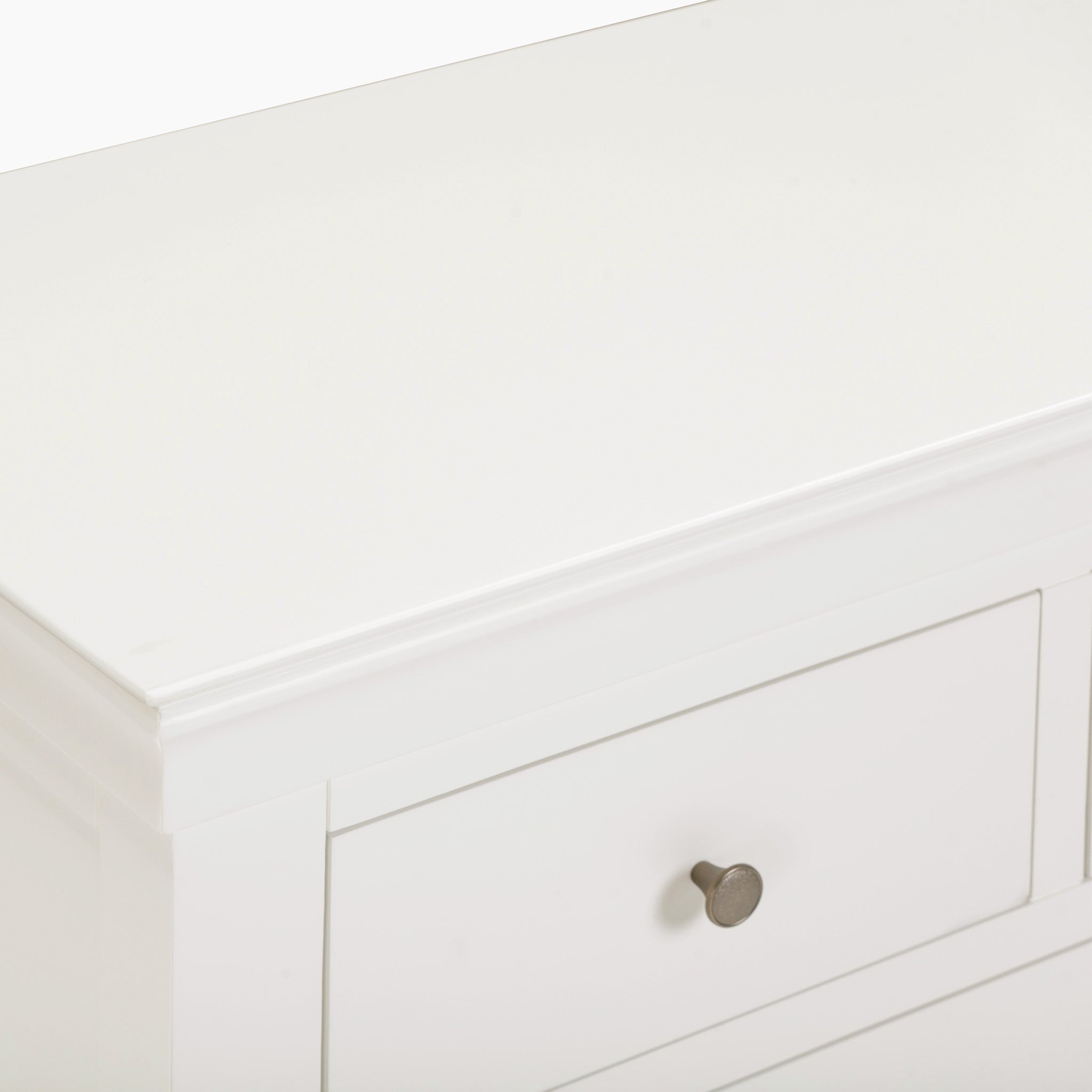 The Chalbury 3 Over 4 Chest of Drawers in Warm White is a charming storage solution, featuring a single drawer adorned with a round metal knob handle, effortlessly merging practicality with style.