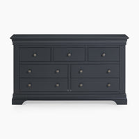 A Chalbury 3 Over 4 Chest of Drawers in Dusky Black, featuring seven drawers with round knobs.