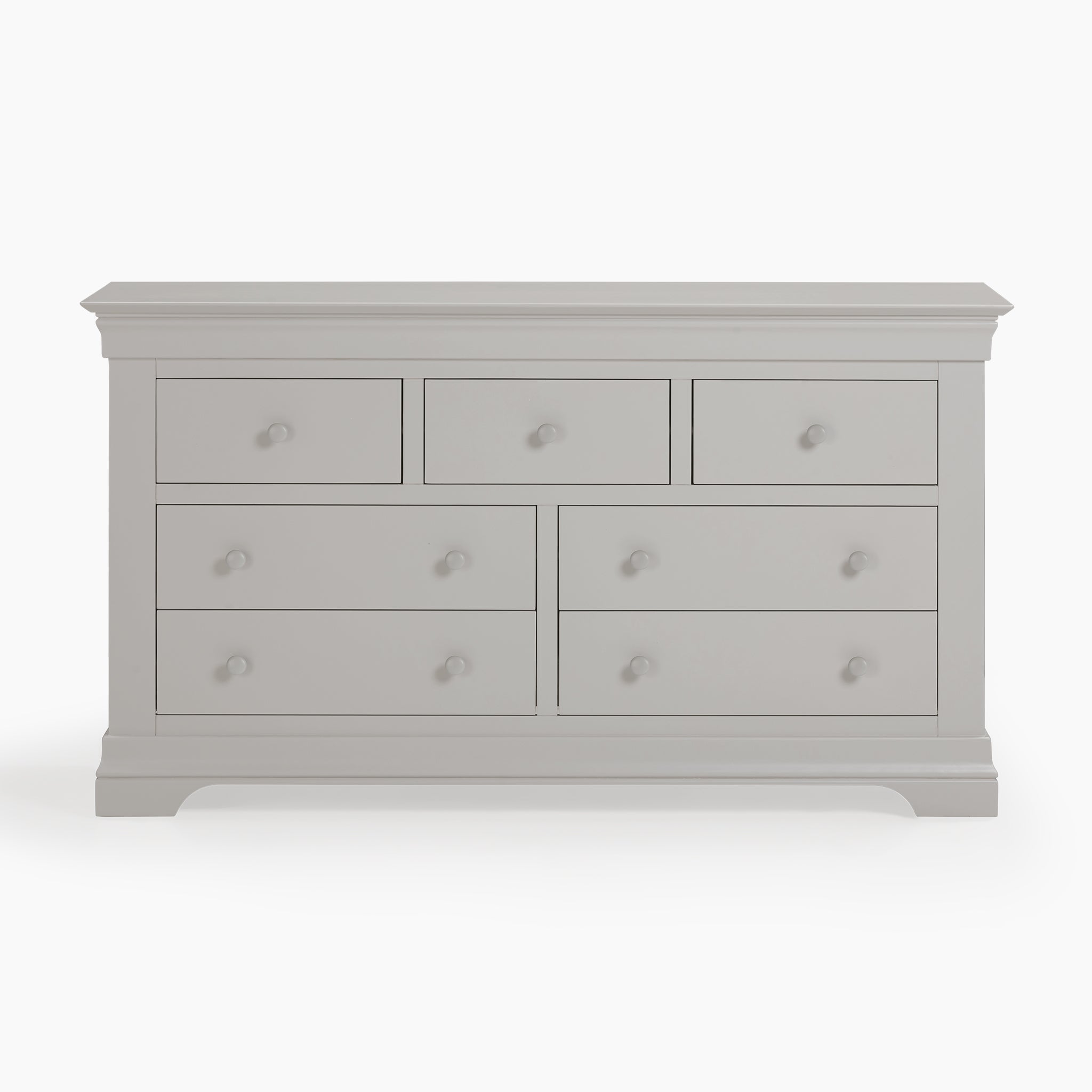 The Chalbury 3 Over 4 Chest of Drawers in Pebble Grey boasts seven spacious drawers with simple round knobs, set against a clean white background, making it an elegant piece of storage furniture.