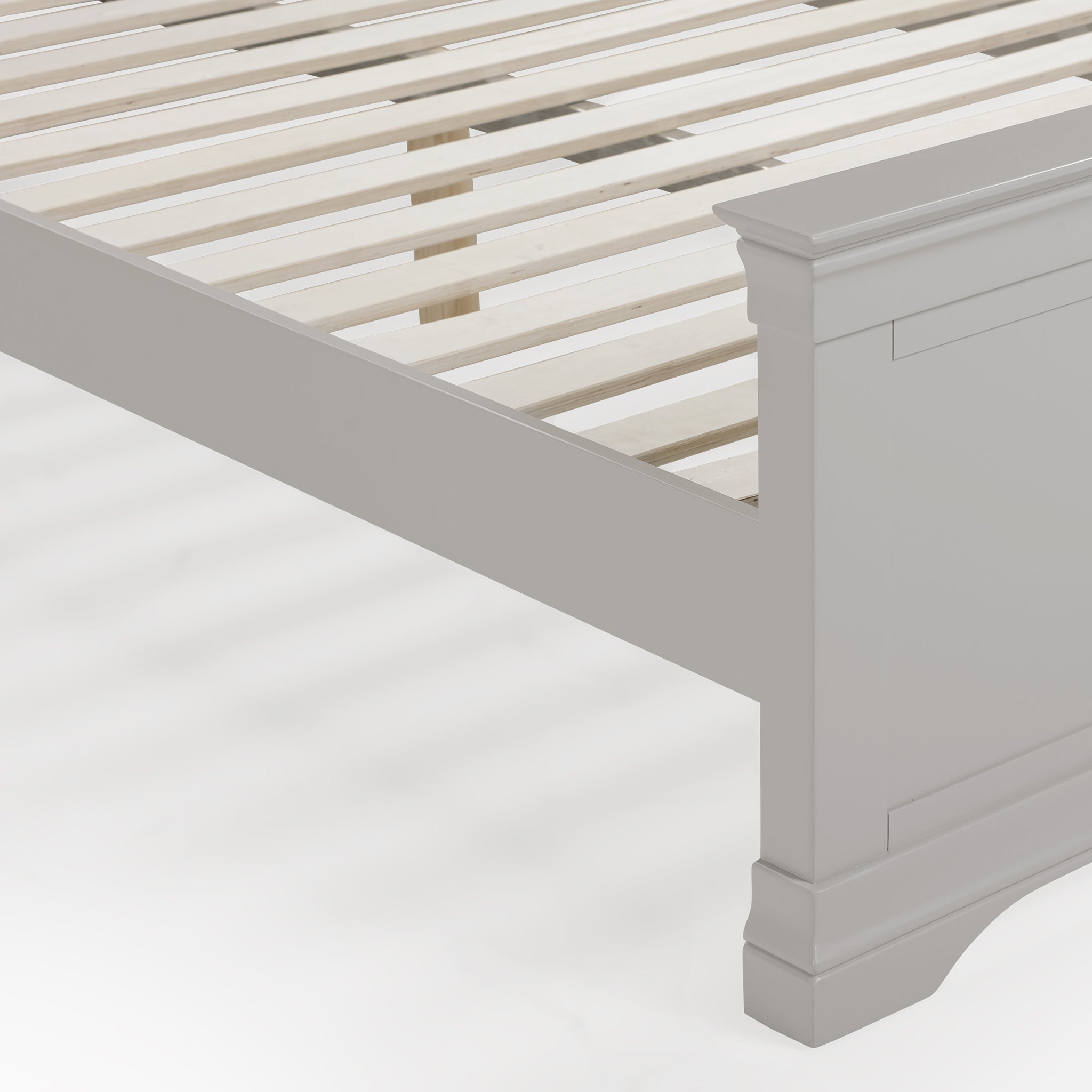 Close-up of the Chalbury 4ft 6" High End Double Bed Frame in Pebble Grey featuring a slatted base and intricately detailed footboard corner, all set against a pristine white background.