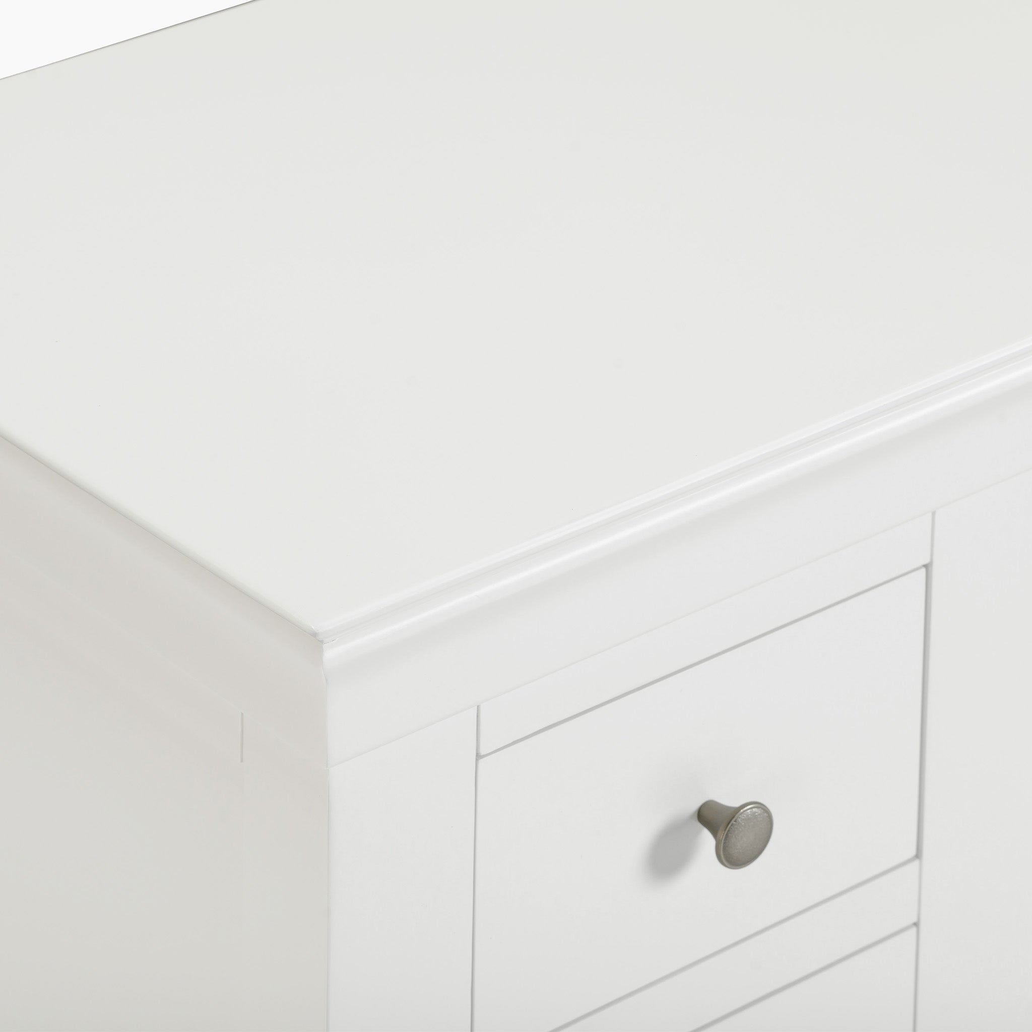 The Chalbury Dressing Table with Drawers in Warm White offers a charming design, featuring two drawers and round metal knobs, making it an ideal choice for a white dresser corner or as a console desk in any room.