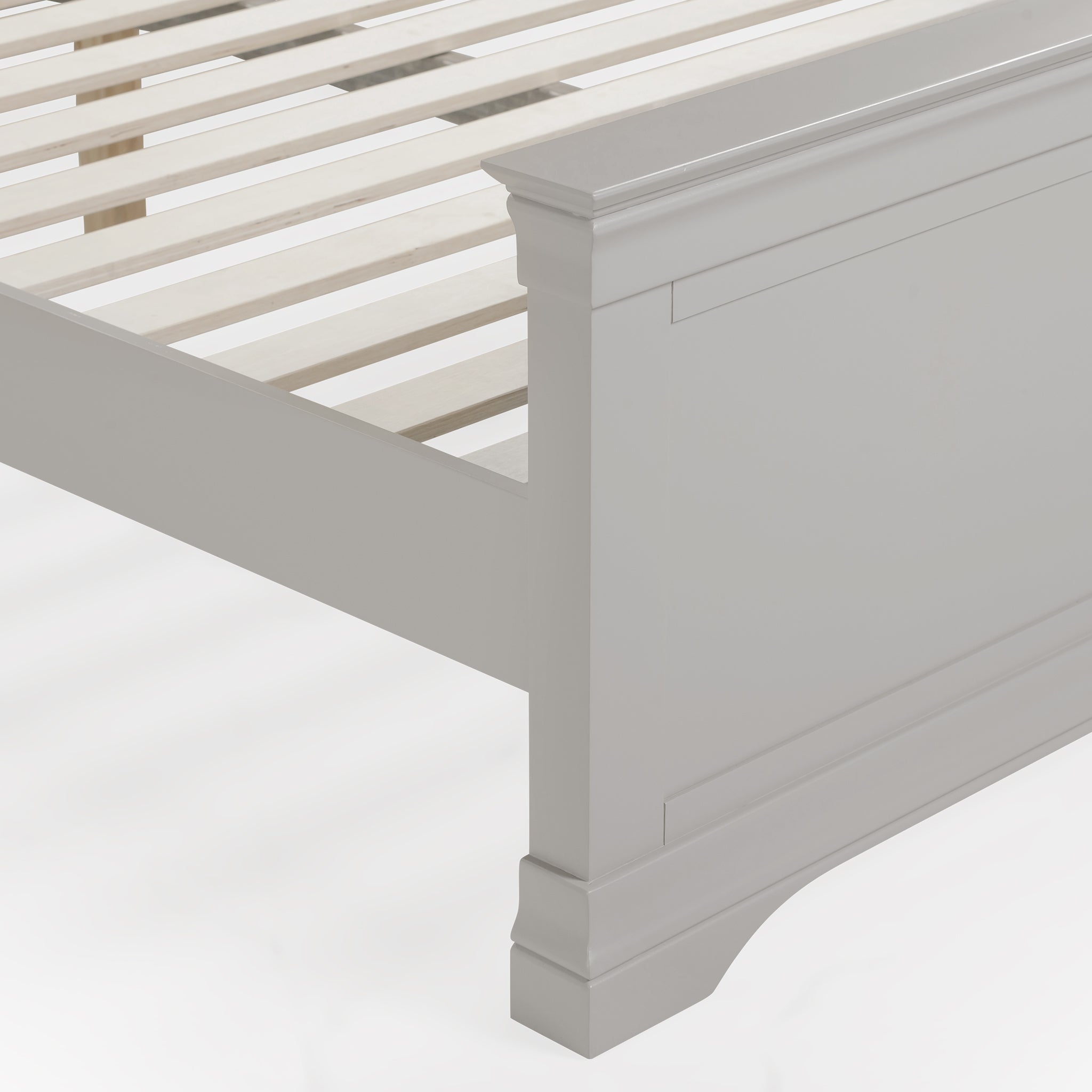 Close-up of the Chalbury 5ft High-End Kingsize Bed Frame in Pebble Grey, featuring wooden slats and intricate carvings on the footboard, ideal for a contemporary design.