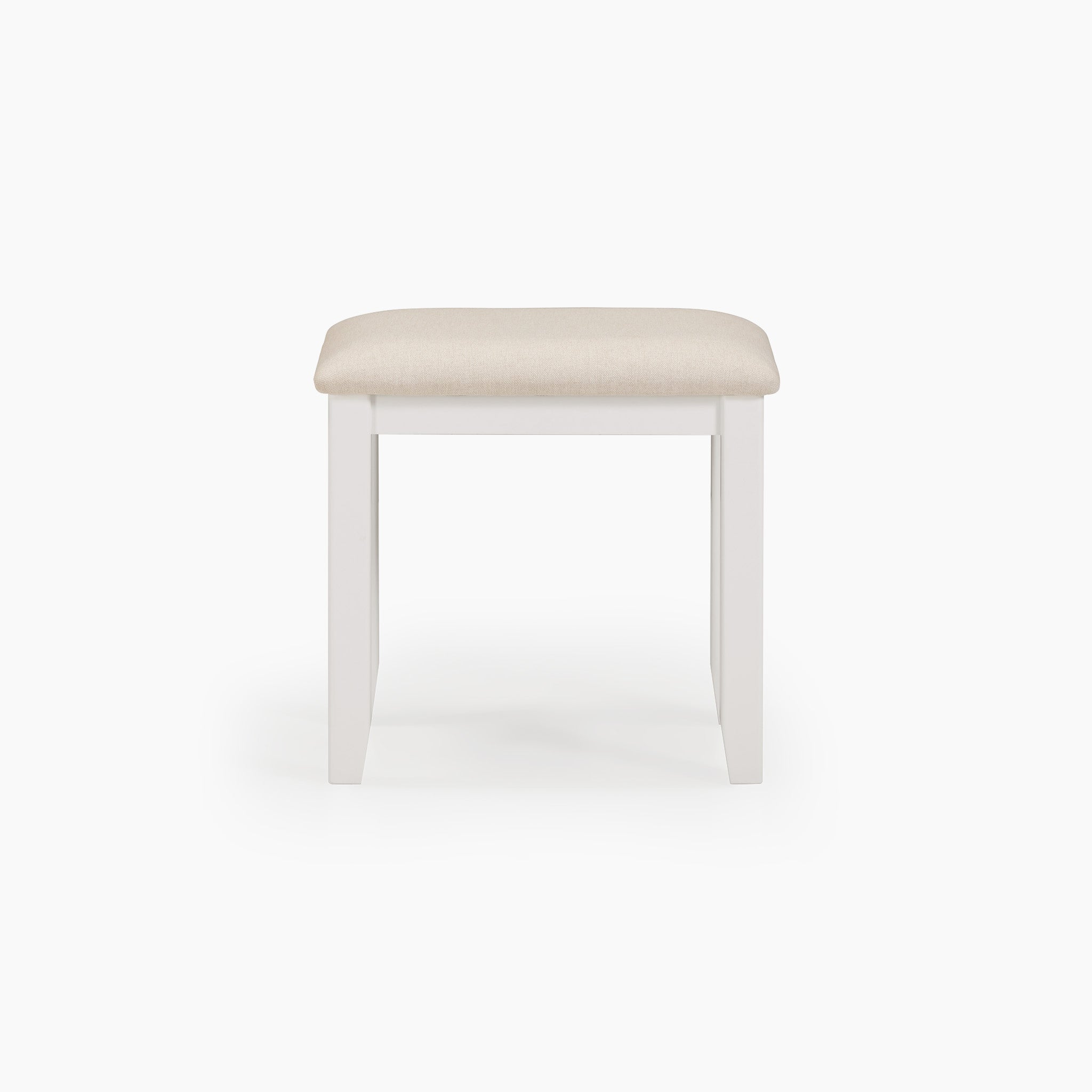 The Chalbury Stool in Warm White features a sleek wooden frame and an integrated beige cushion, beautifully set against a white backdrop for a classic appearance.