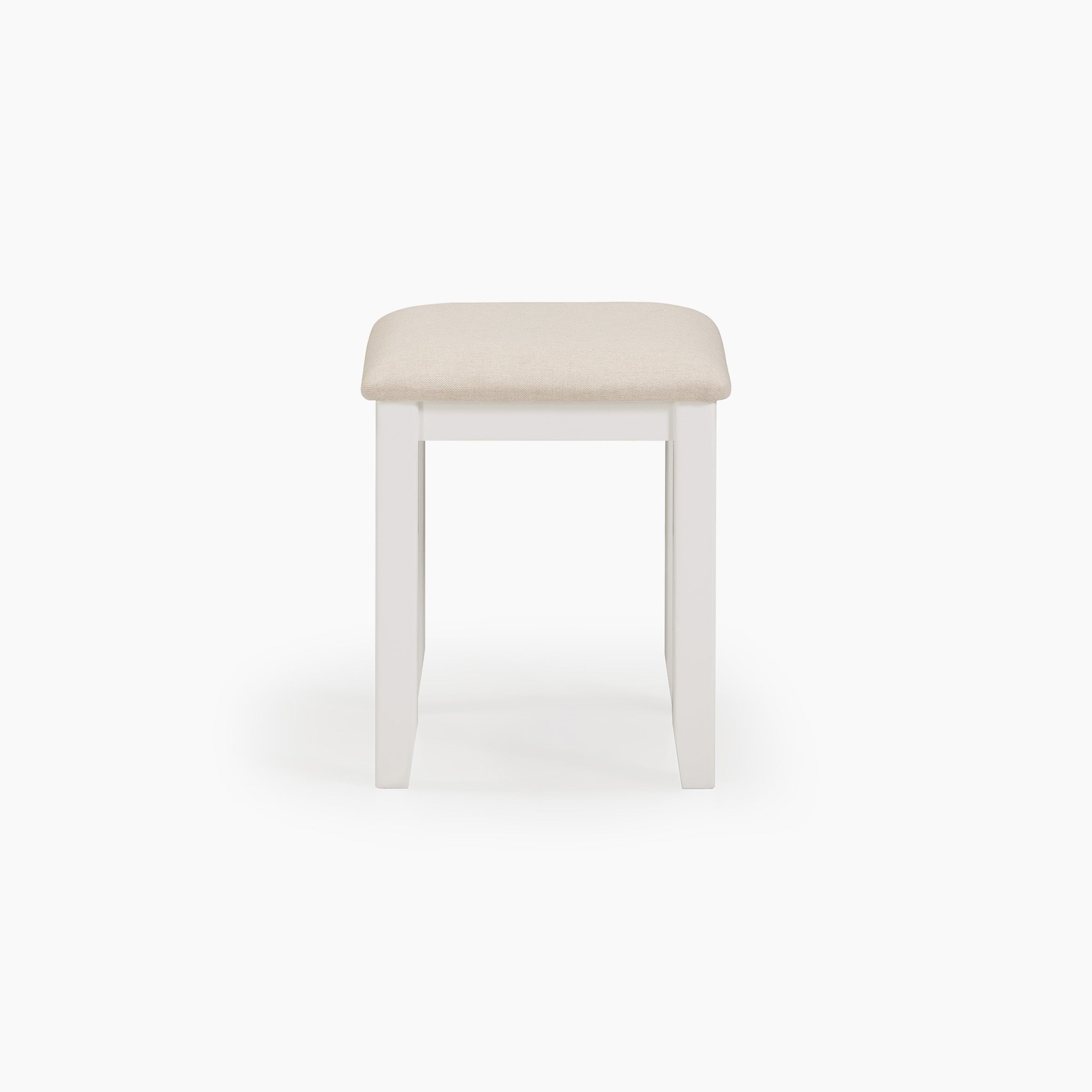 The Chalbury Stool in Warm White comes with a built-in cushion that has a beige seat, perfectly complementing its crisp white design.