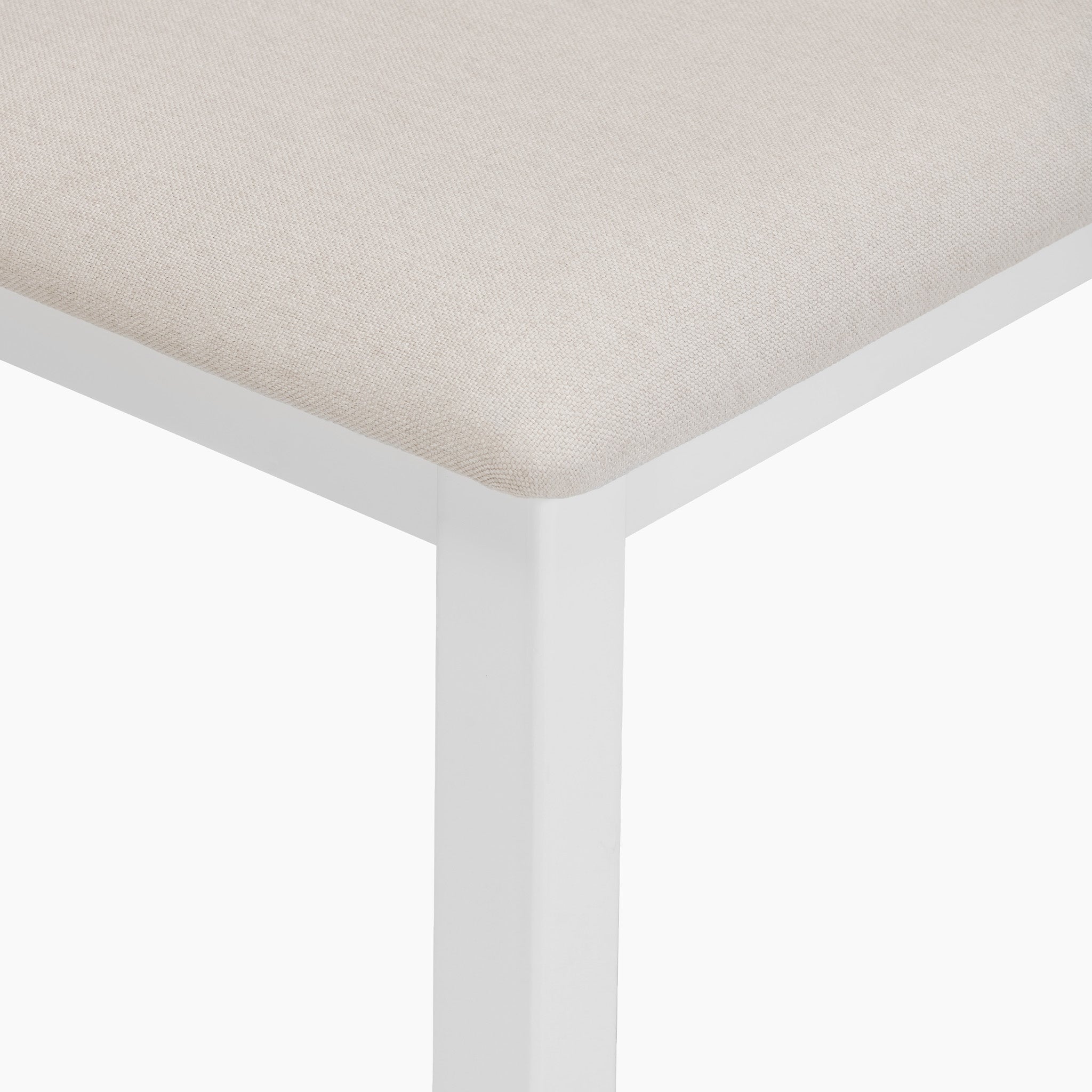 Close-up of the Chalbury Stool in Warm White showcasing a beige fabric seat with an integrated cushion and stylish warm white metal legs against a clean white background.