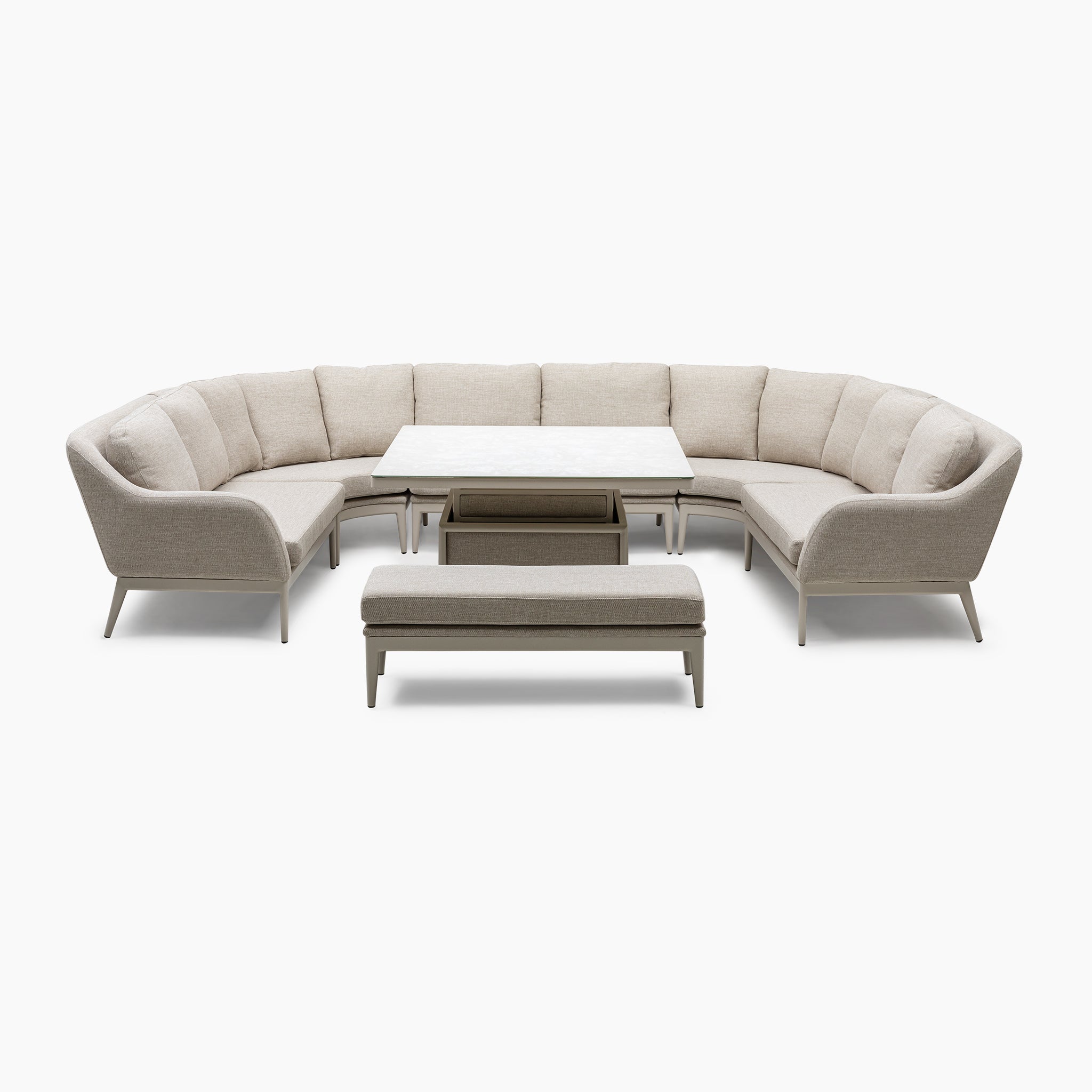 The Luna U-Shape Outdoor Fabric Corner Dining set in Fawn includes a curved sectional sofa, a rectangular coffee table, and a bench, all centered around a rising firepit table for cozy evenings.