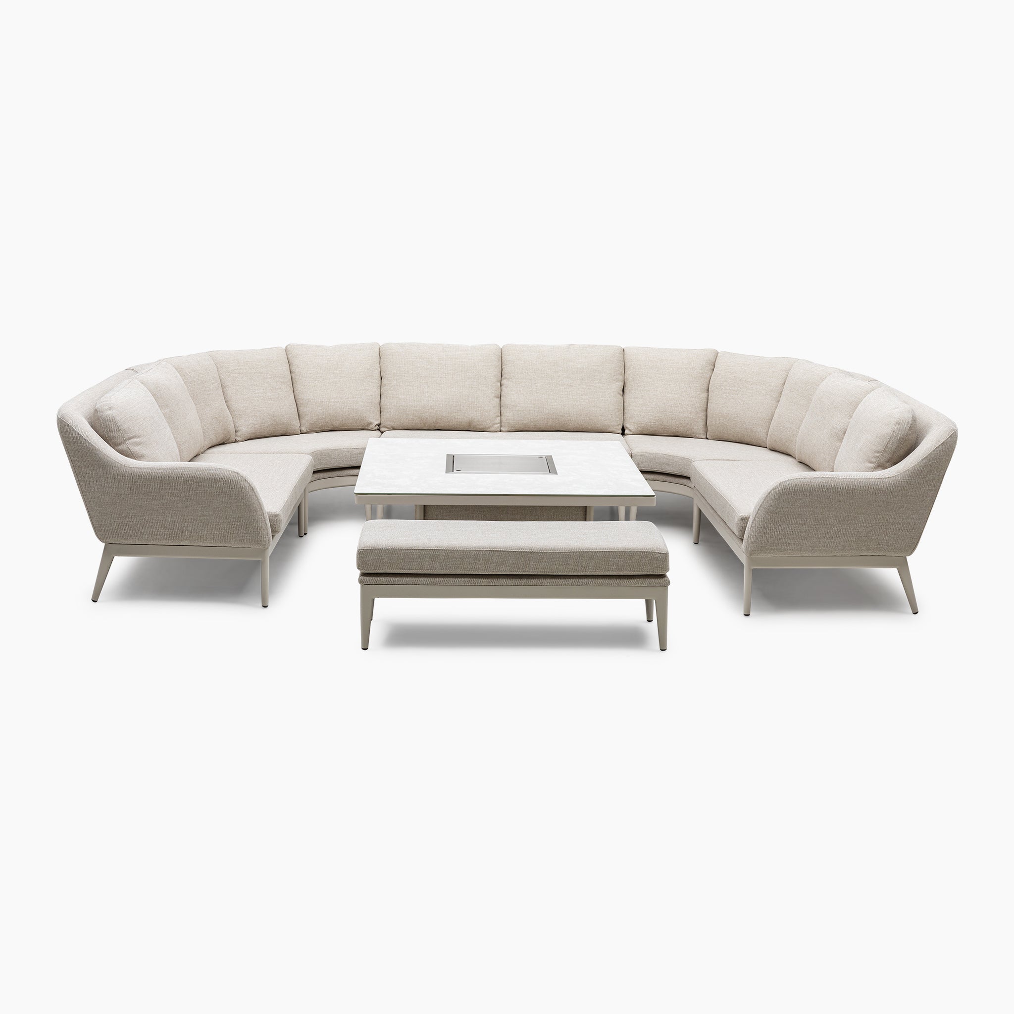 U-shaped fawn sectional with Luna outdoor fabric surrounds a low-maintenance rectangular table with a matching bench, featuring an elegant rising firepit design.