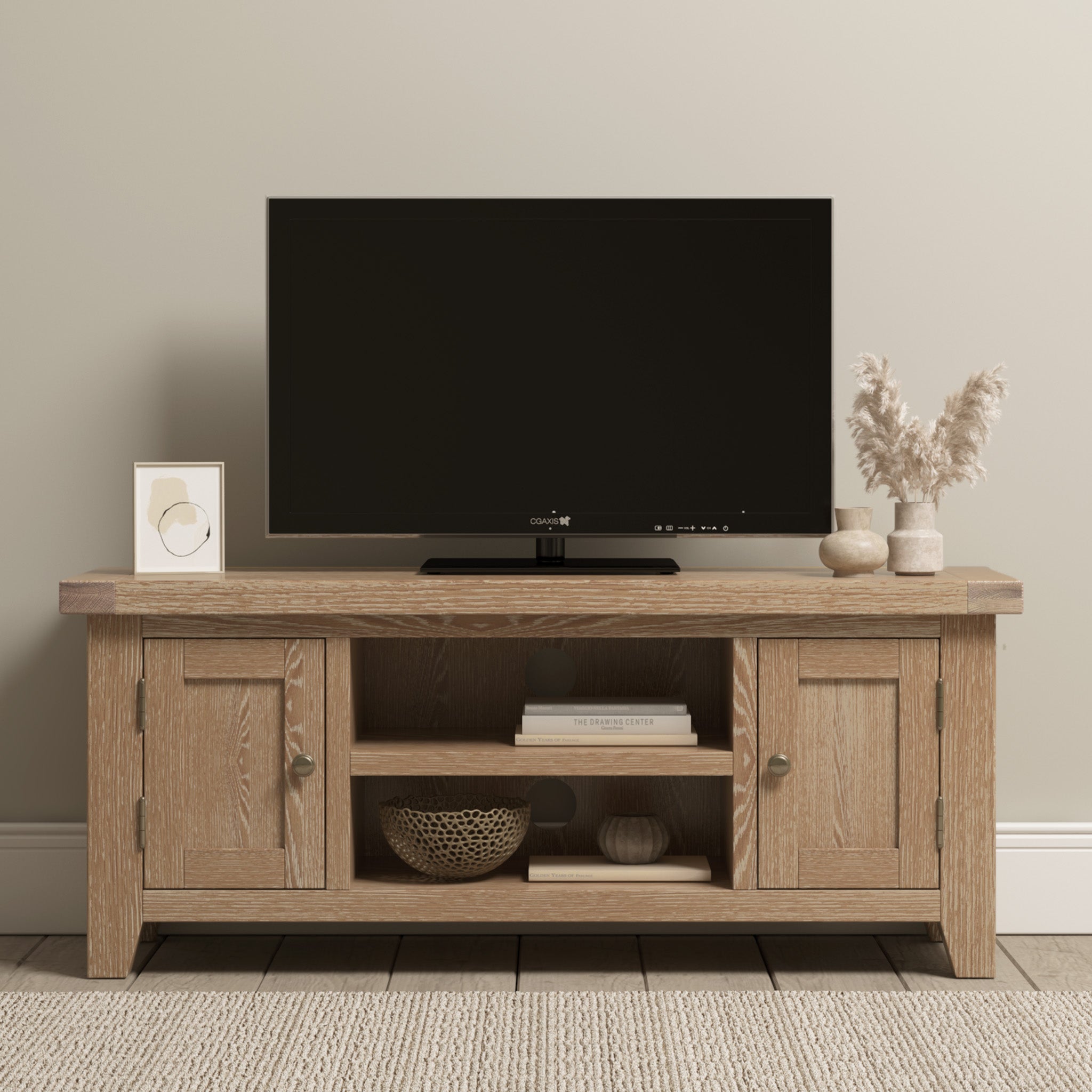 The Burford 120cm Media Unit in Natural Oak highlights a wooden TV stand displaying a flat-screen TV, decorative vase, picture frame, books, and a woven basket on a beige rug. Its natural oak finish seamlessly enhances any decor.