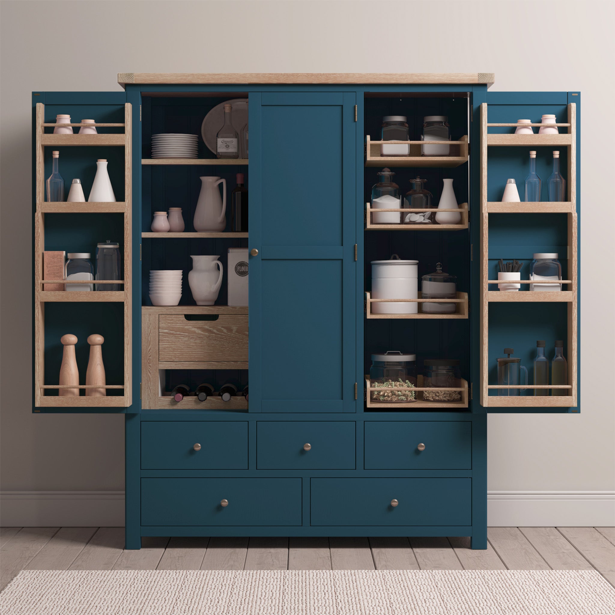 Introducing the Burford Triple Larder Unit in Navy Blue: a chic kitchen cabinet with open doors that beautifully display dishes, jars, and various storage items on its shelves and drawers. With a solid oak top, it combines functionality with elegance to enhance your culinary space.