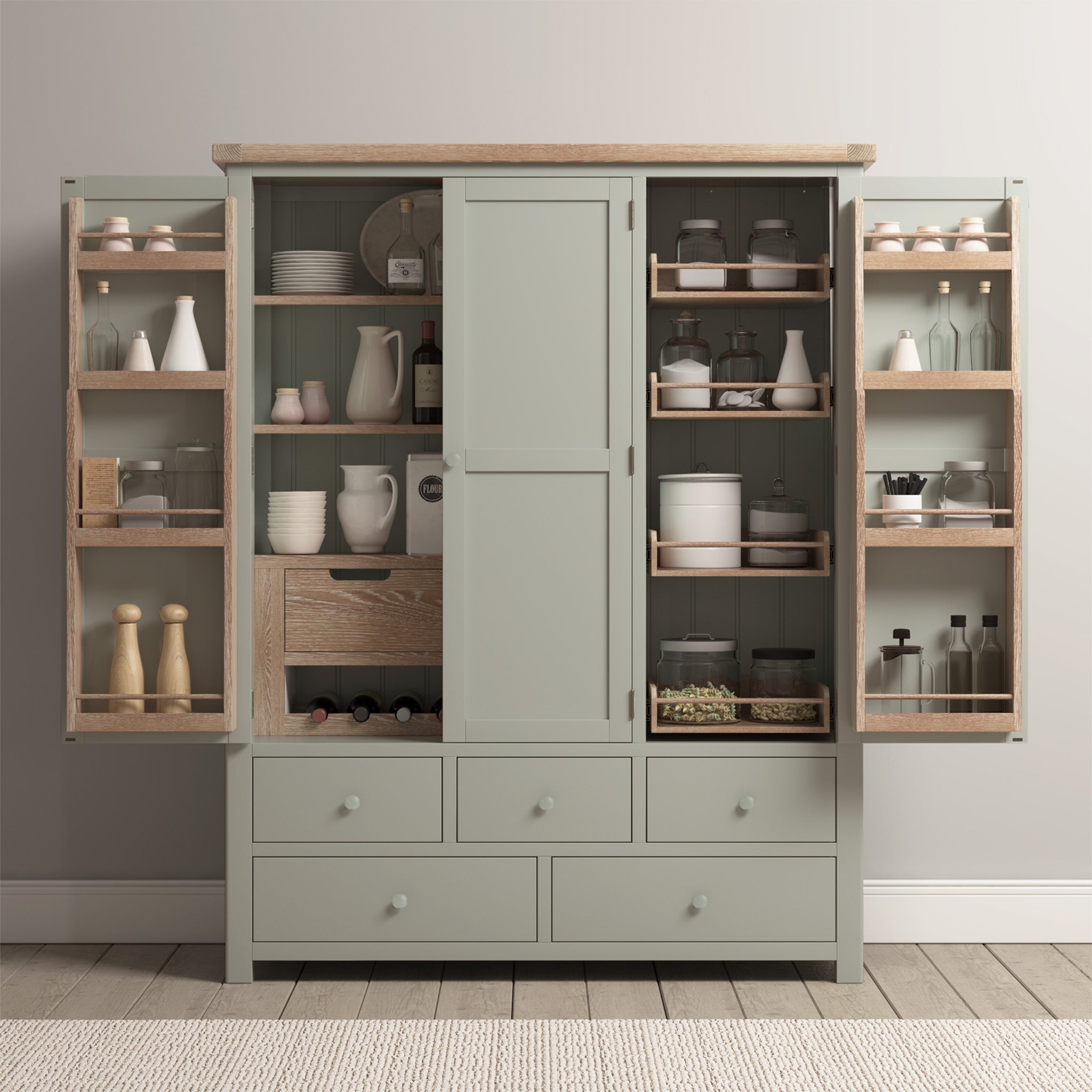 The Burford Triple Larder Unit in Sage Green, with its open doors, showcases an organized space filled with jars, dishes, and utensils neatly arranged on wooden shelves.